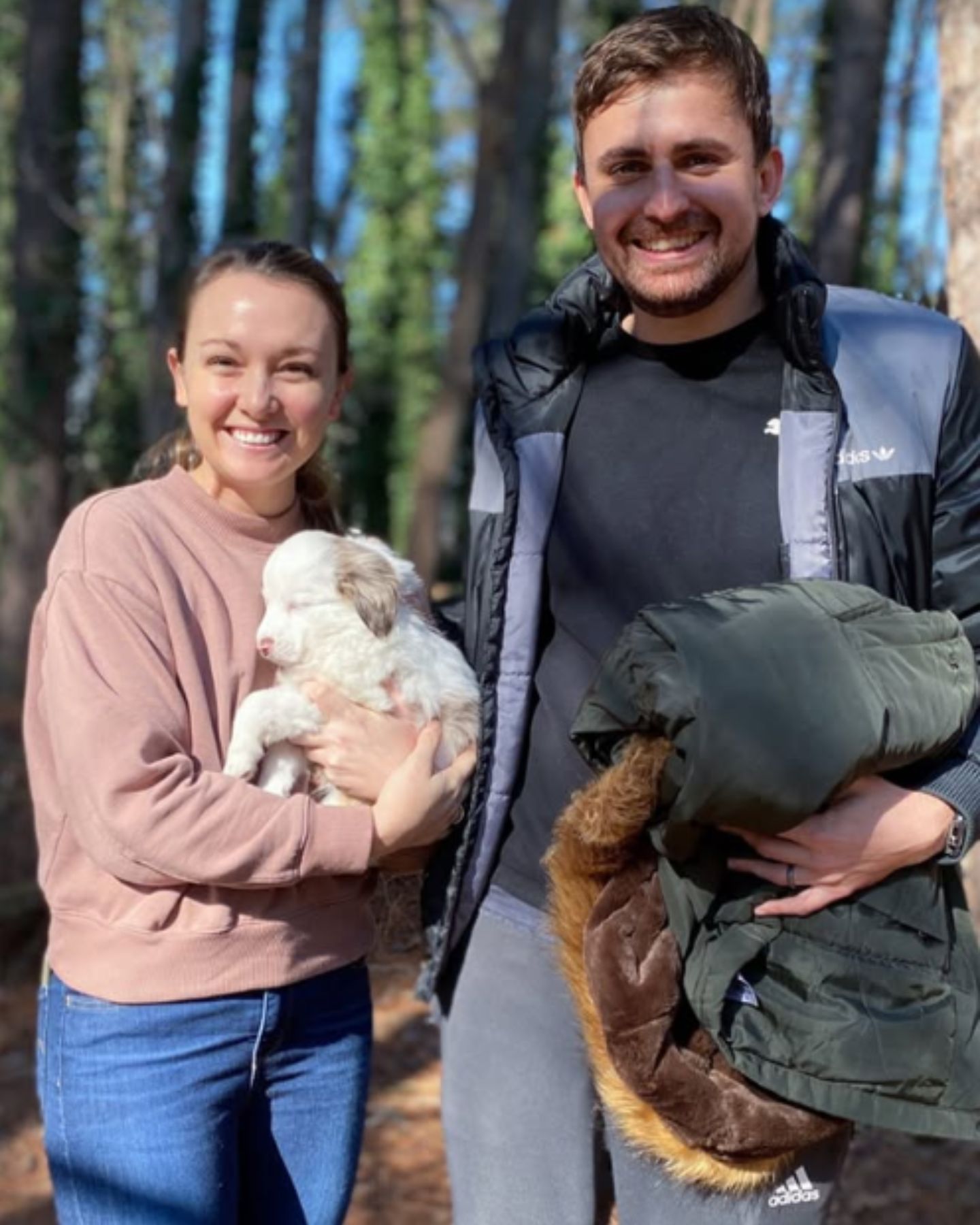 man and woman with a puppy