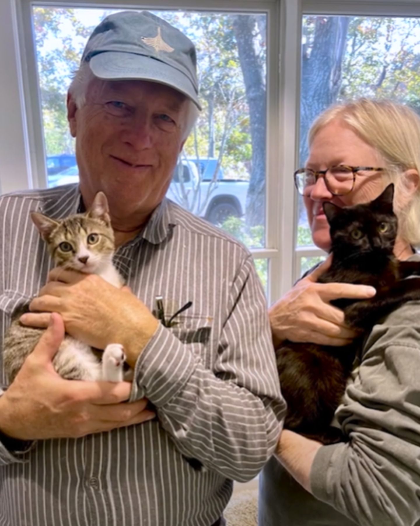man and woman with cats