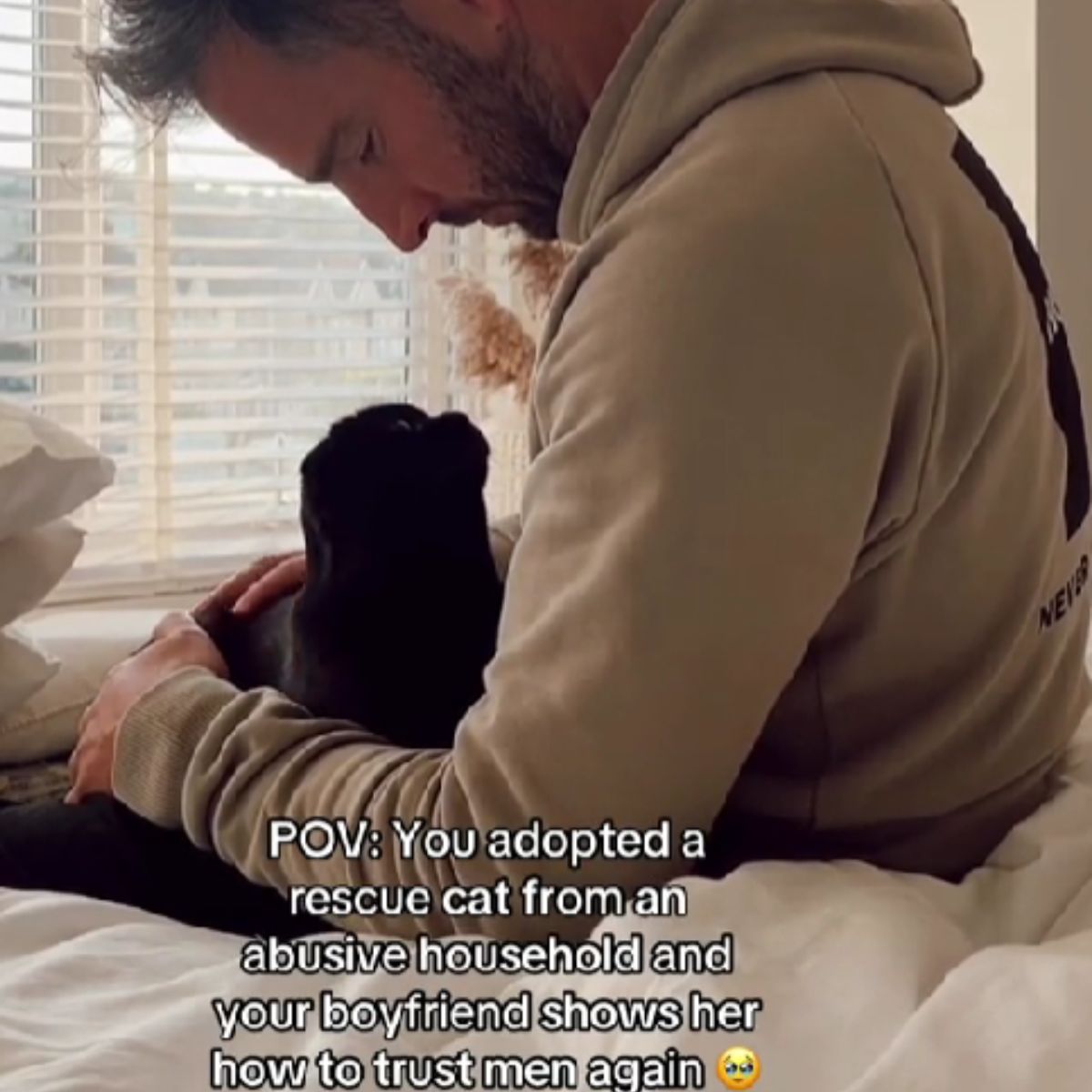 man comforting the cat