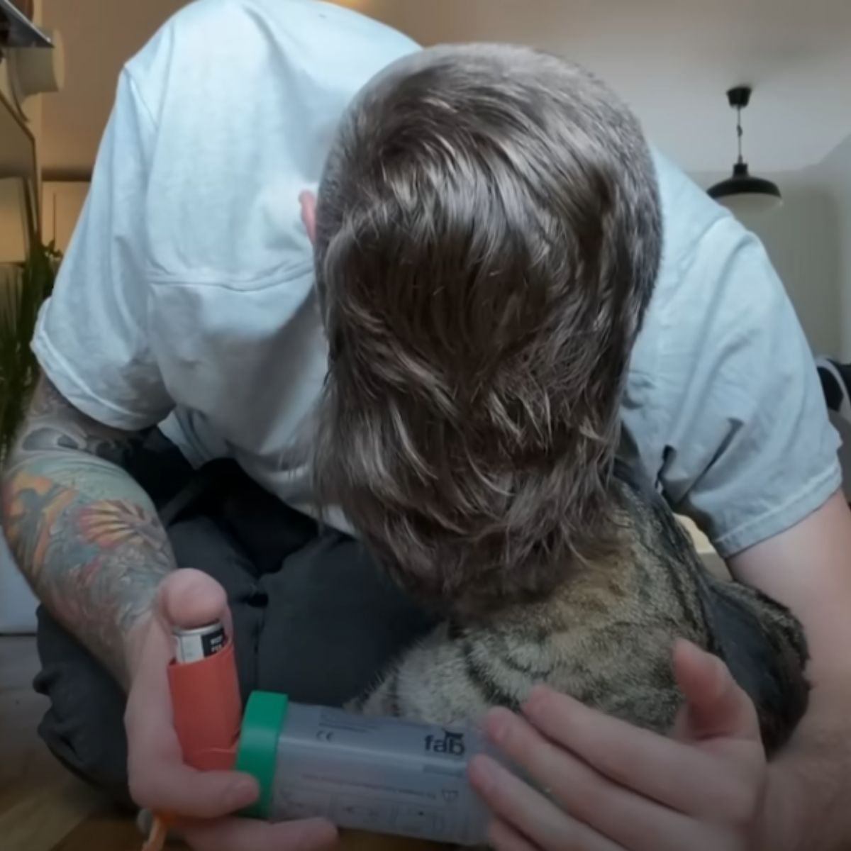 man hugging the cat