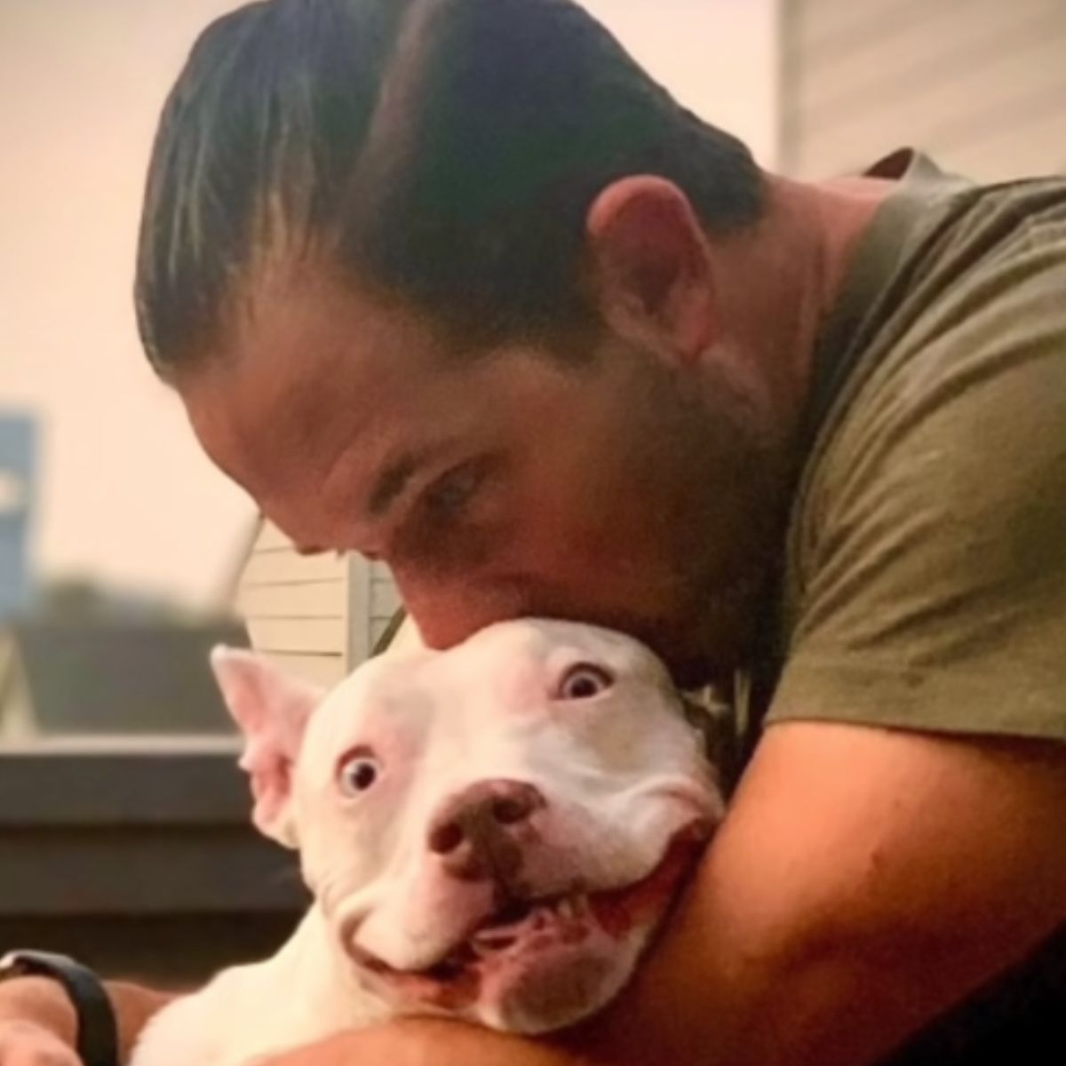 man hugging the dog
