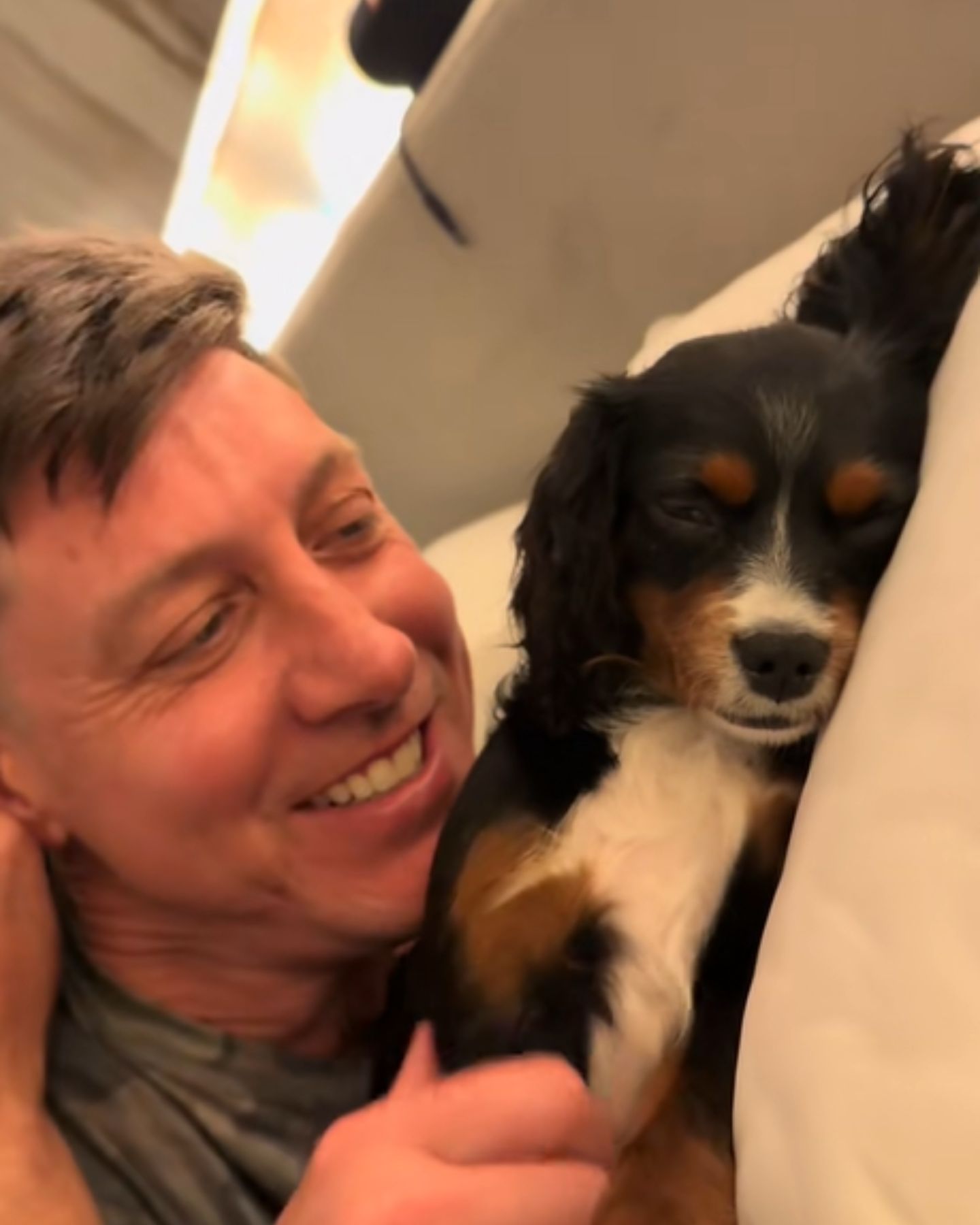 man looking at sleeping dog