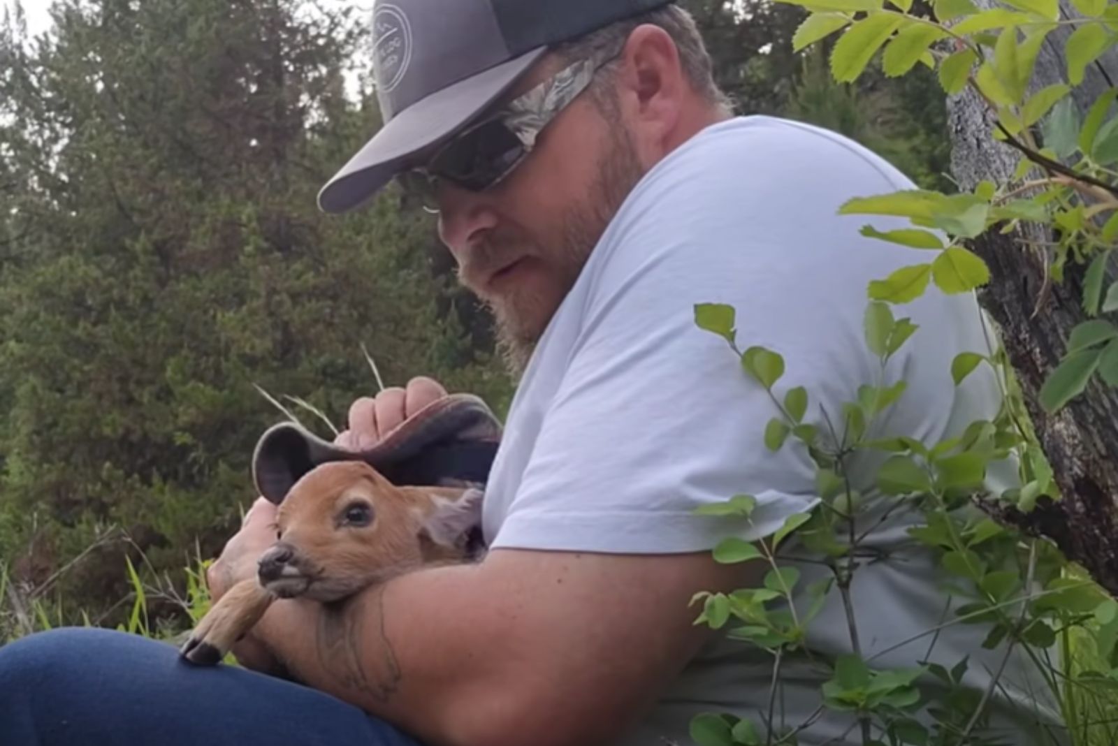 man with rescued baby deer