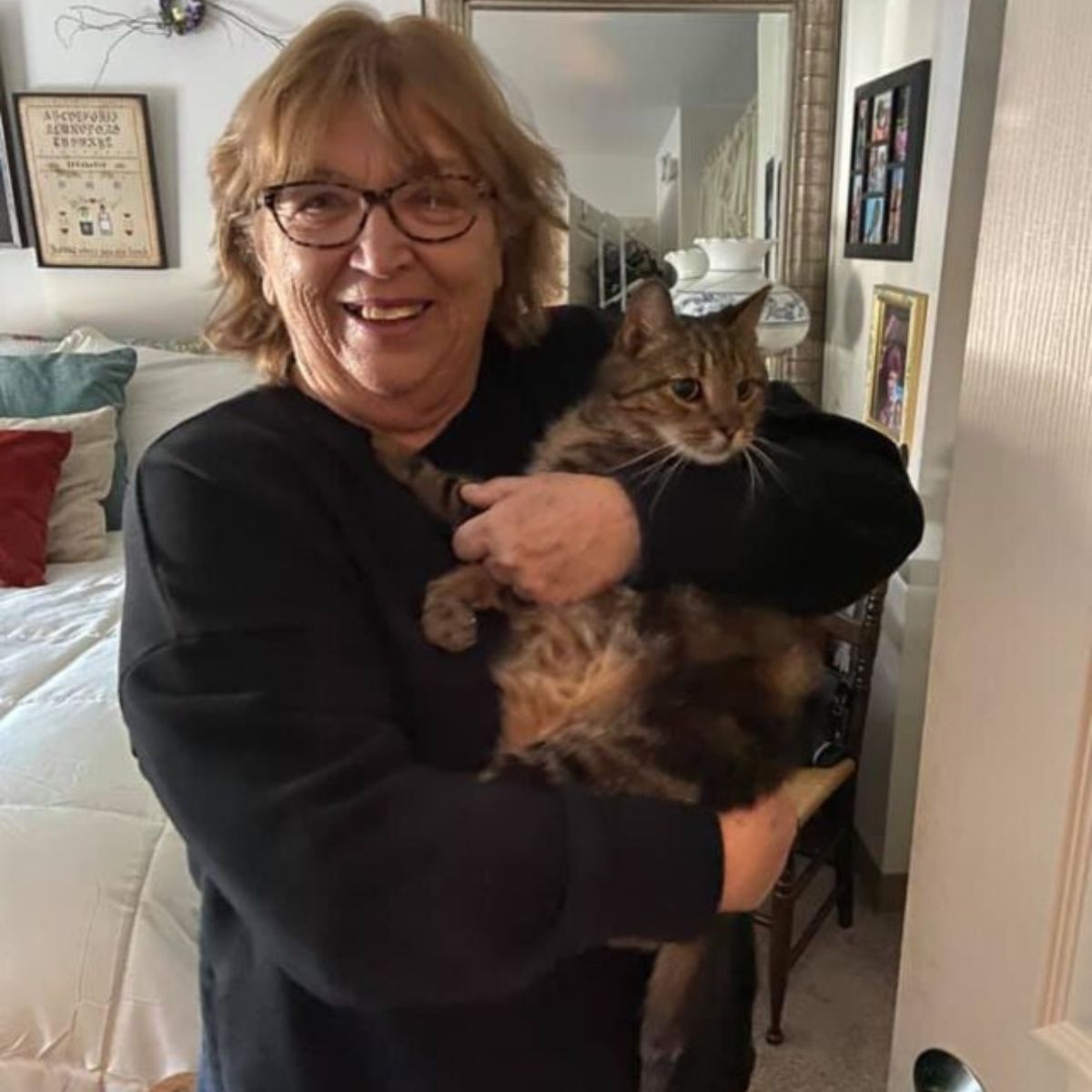 older woman holding a cat