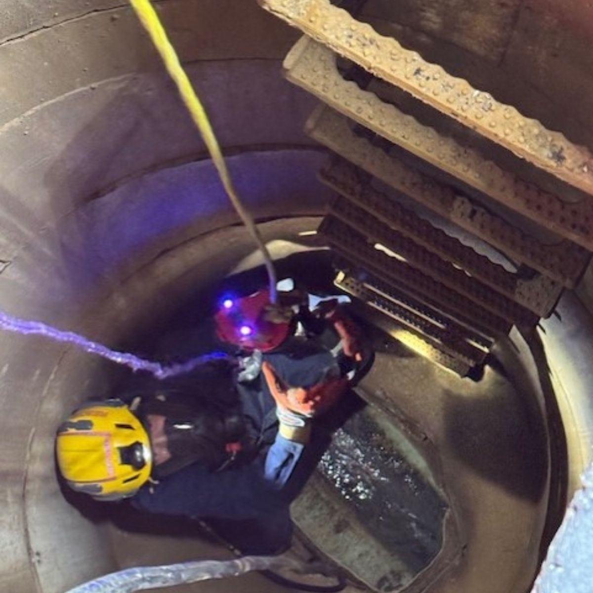 rescuers saving a cat in storm drain
