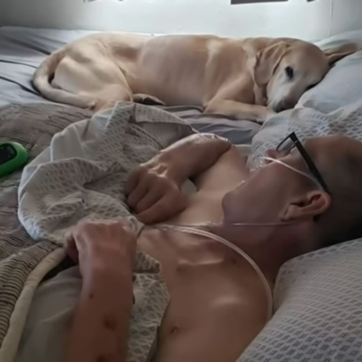 sick man and dog lying next to each other