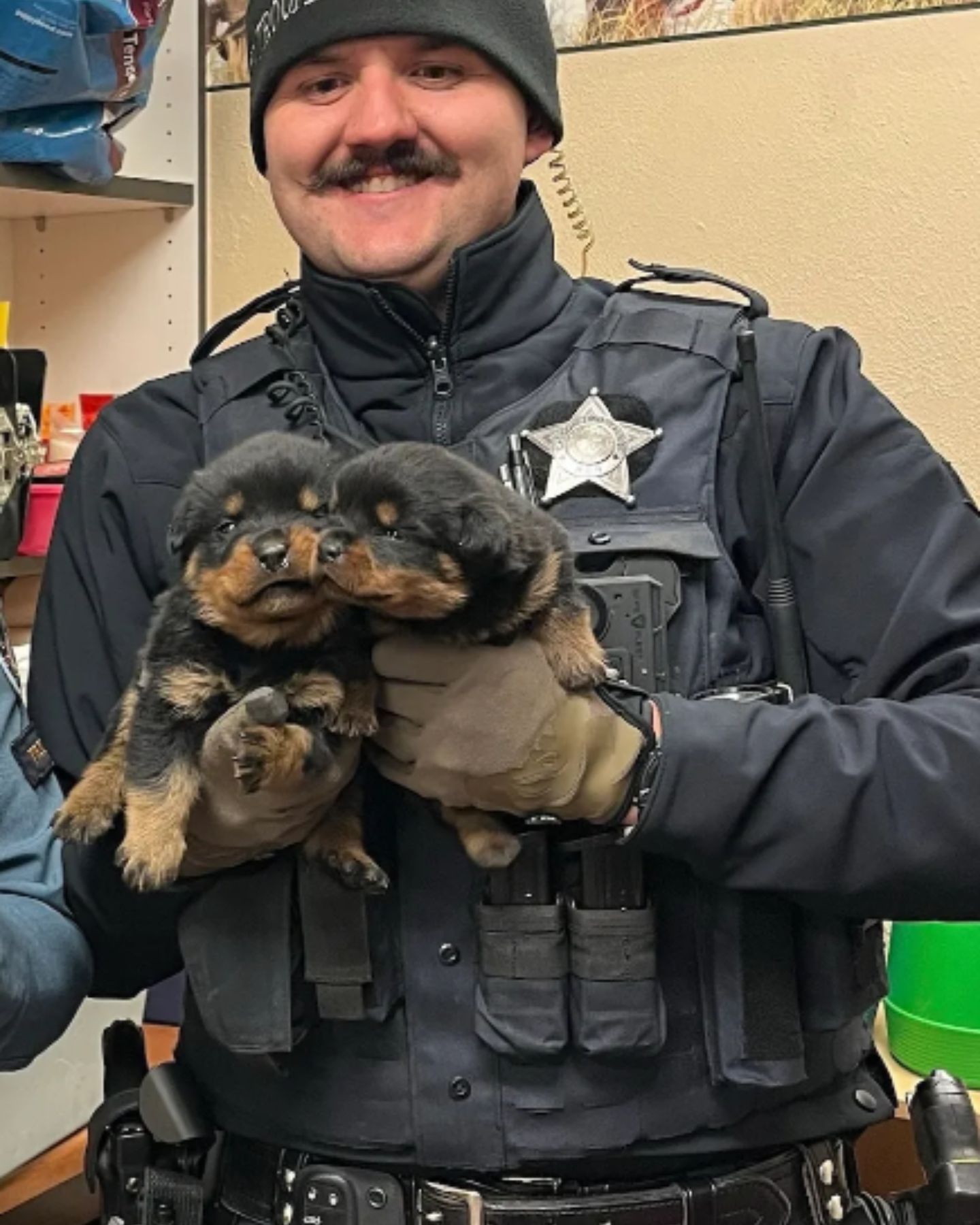 smiling policeman with two little dogs