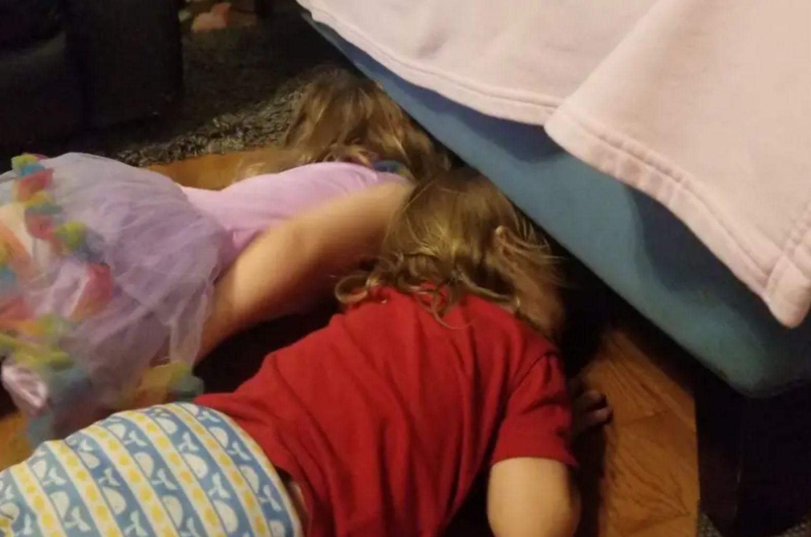two little girl looking under the bed