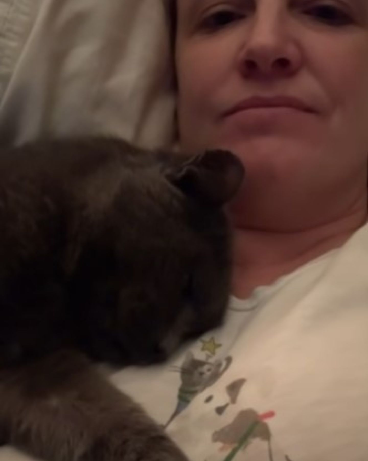 woman and cat sleeping together