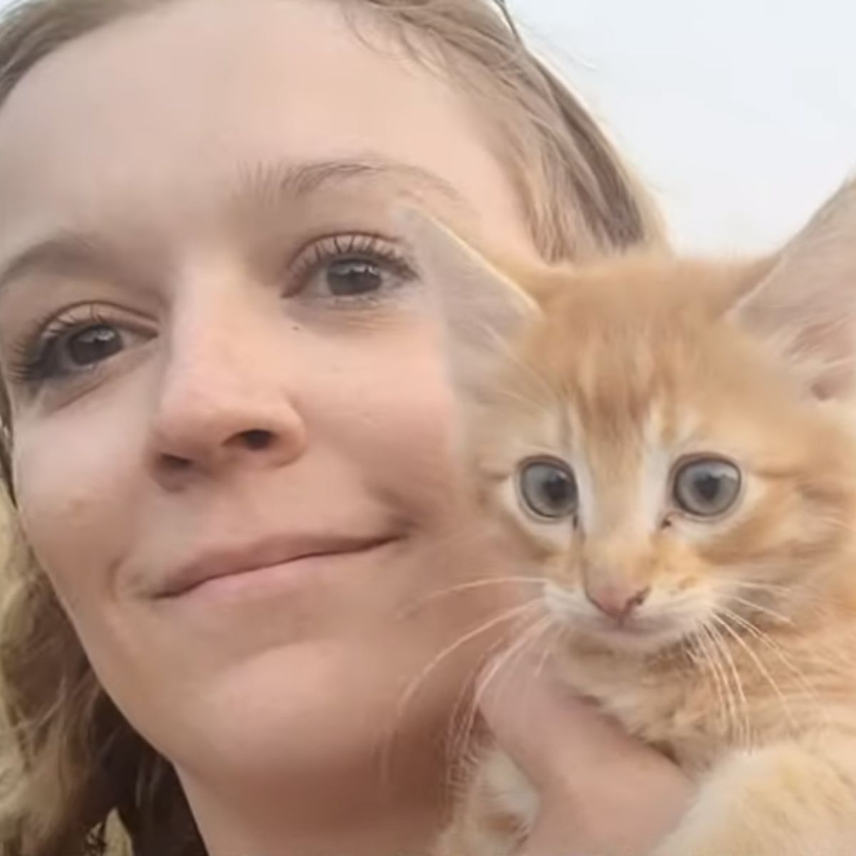 woman and ginger kitten