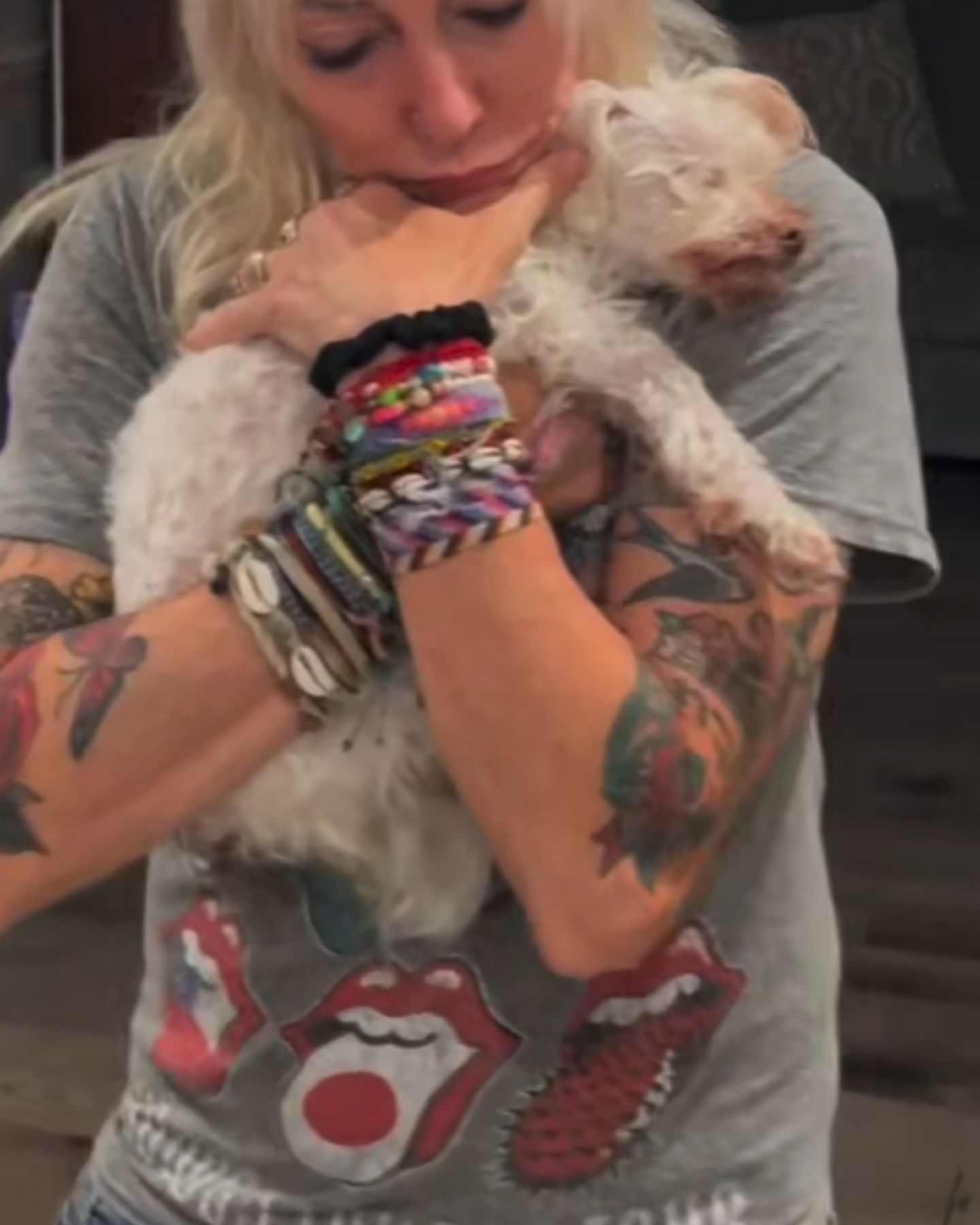 woman cuddles with a blind and deaf dog