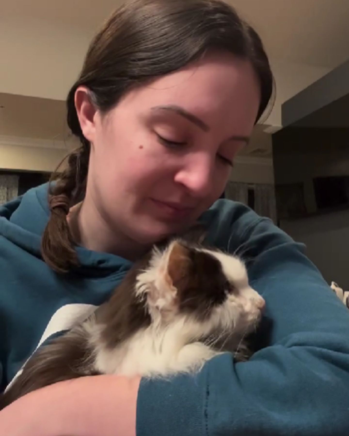 woman cuddling with the cat