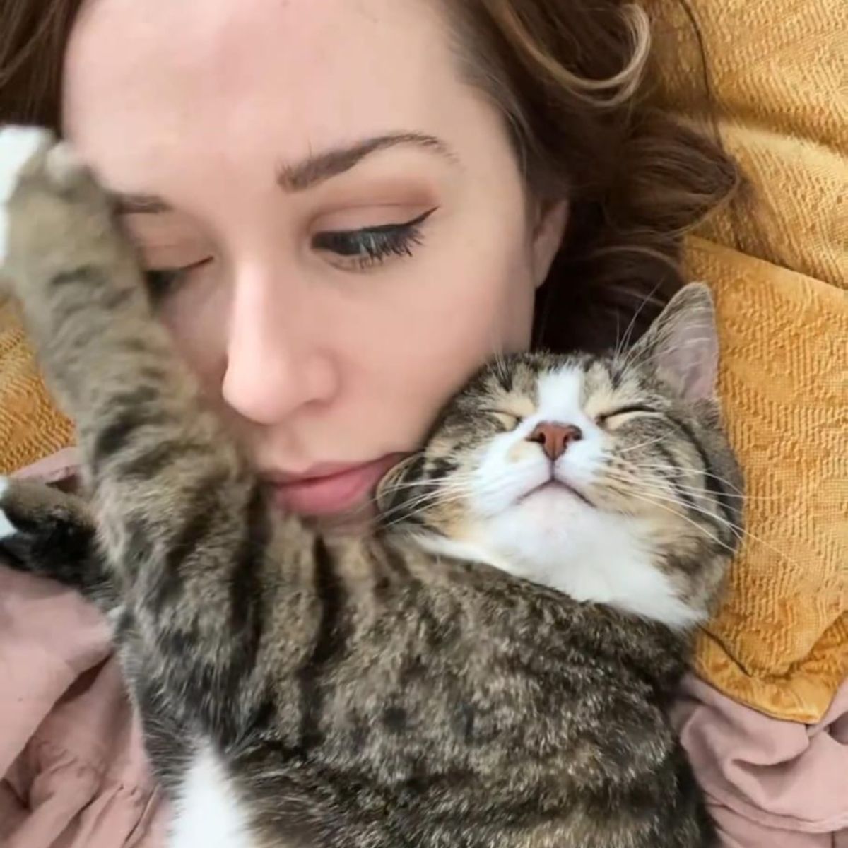 woman cuddling with the cat