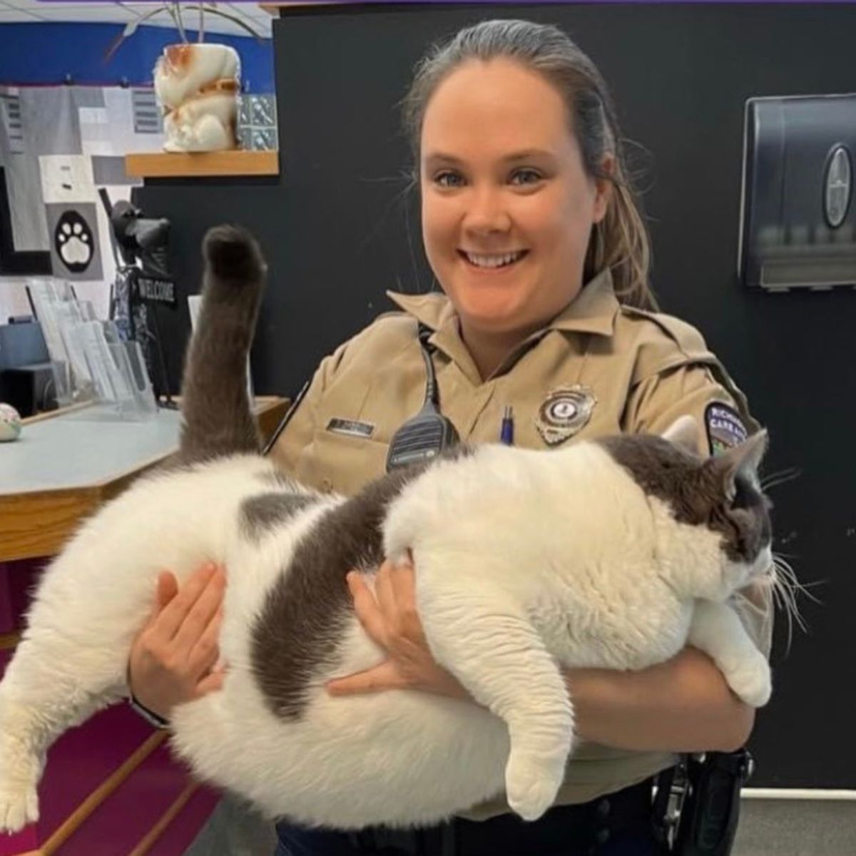 woman holding a forty pound cat