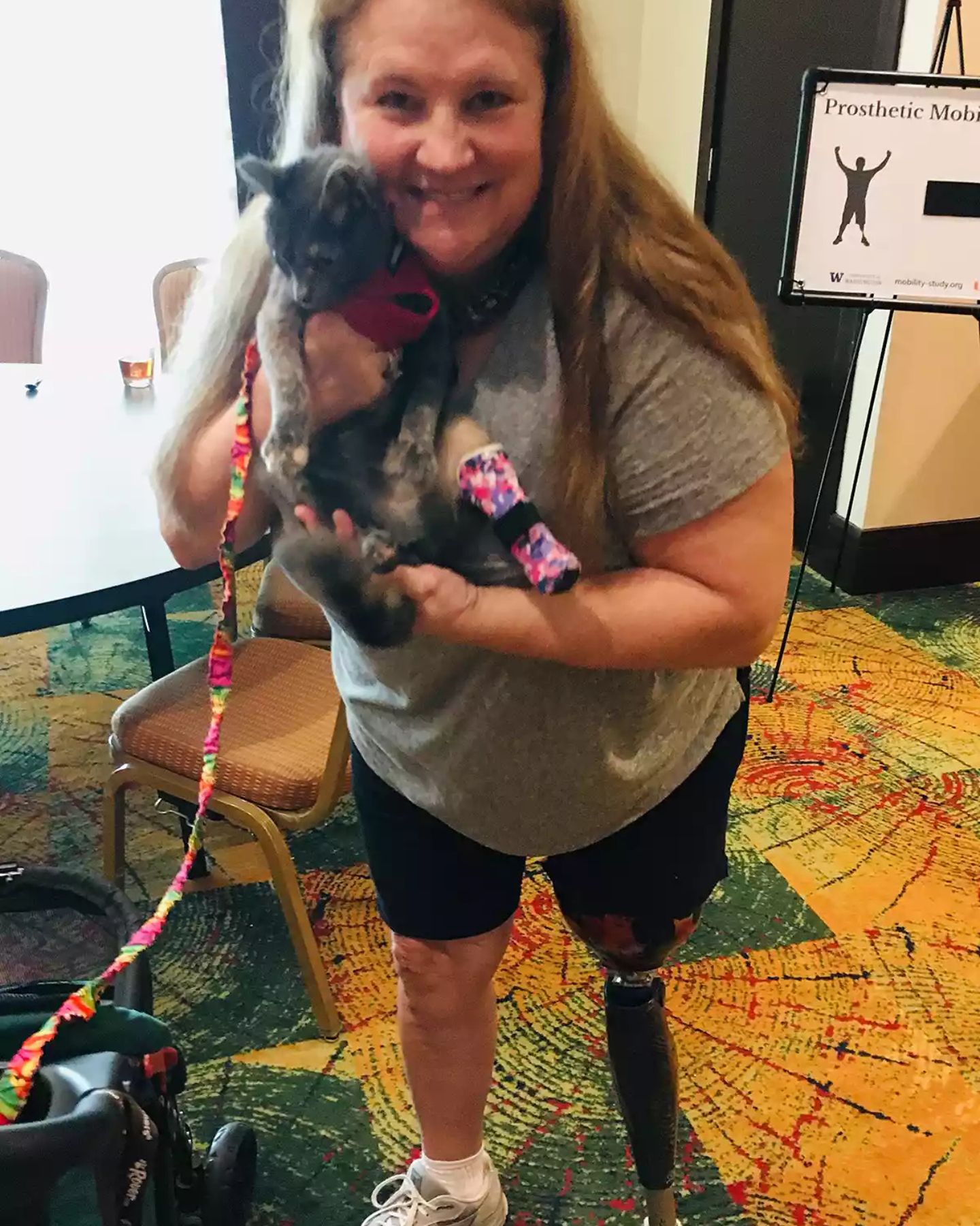 woman holding the amputee cat