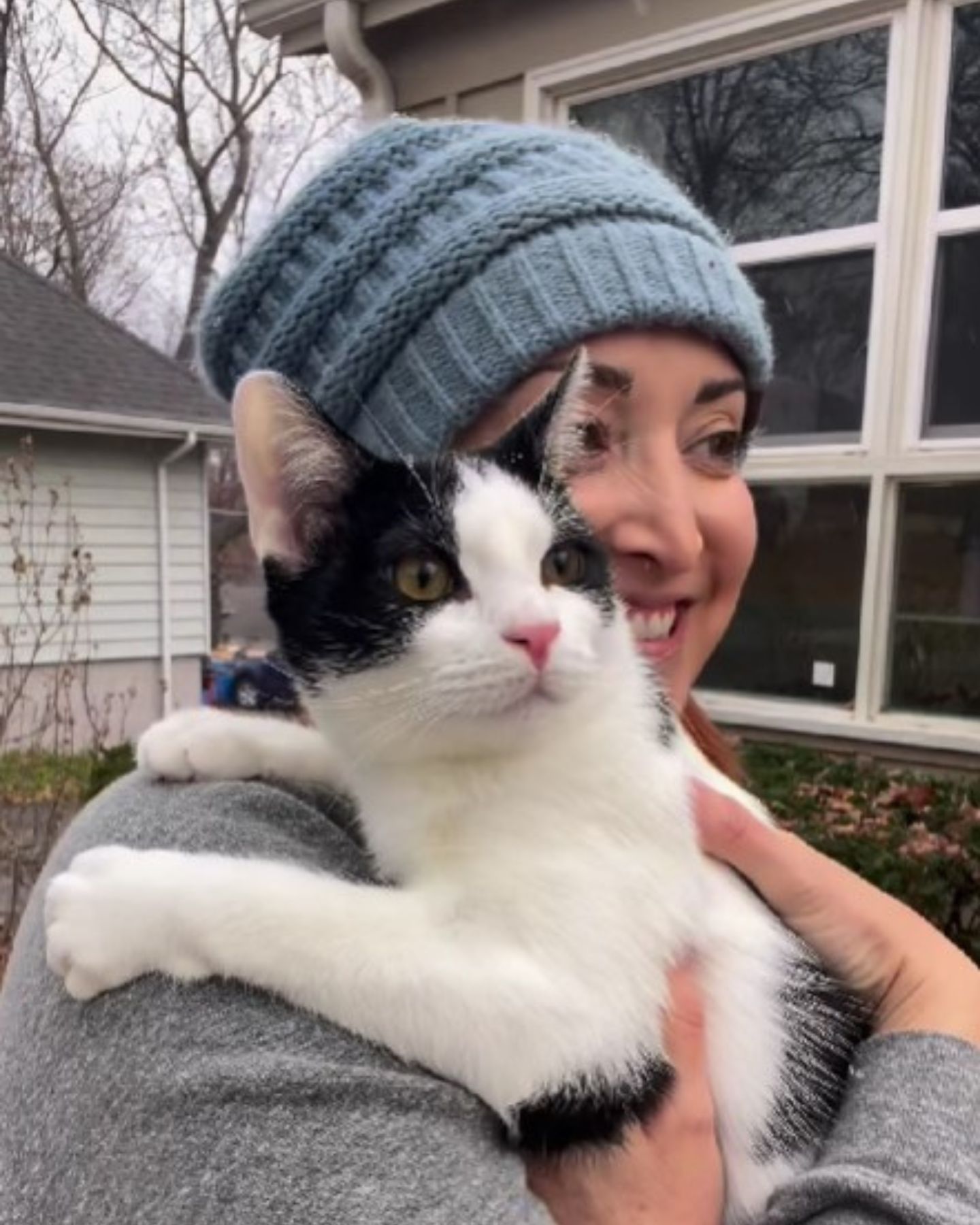 woman holding the kitten outdoors