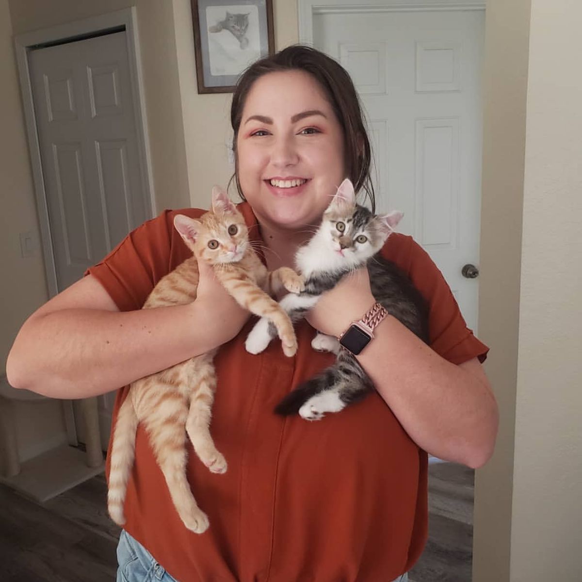 woman holding two kittens