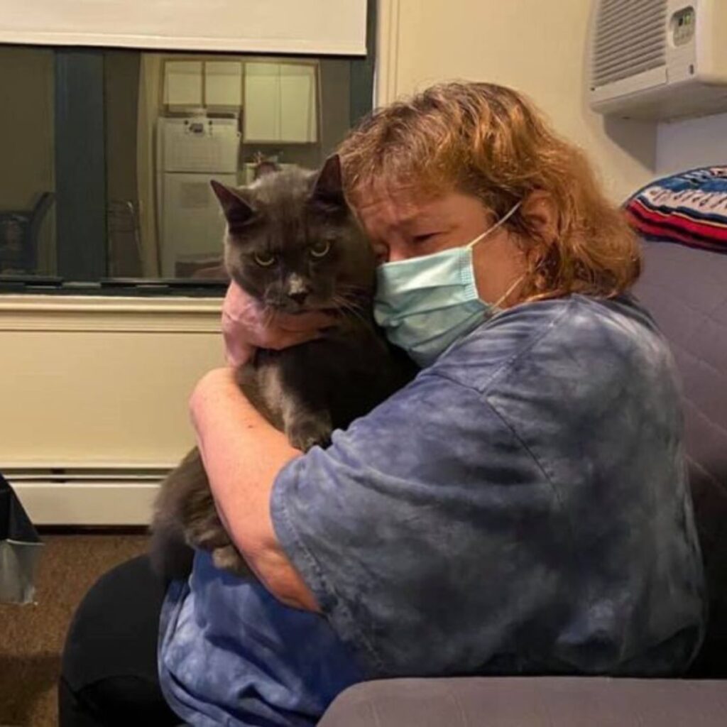 woman hugging her cat