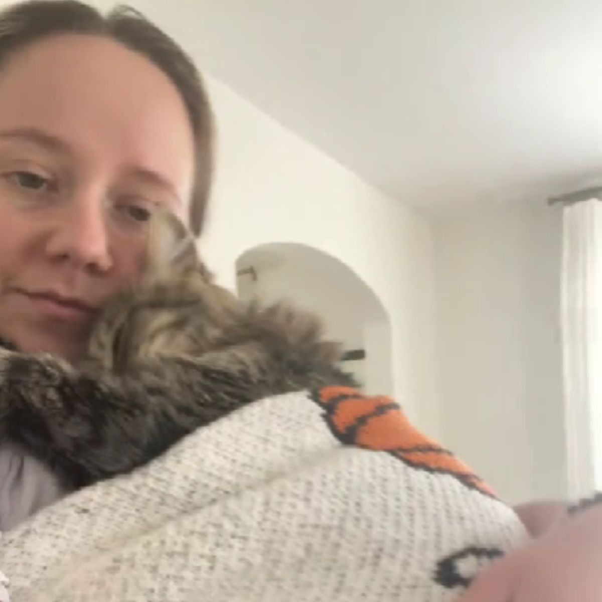 woman hugging shelter cat