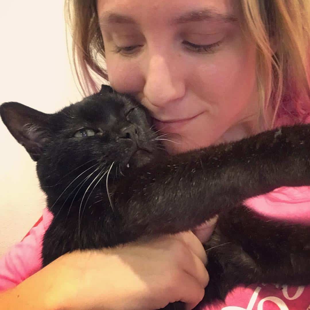 woman hugging the cat