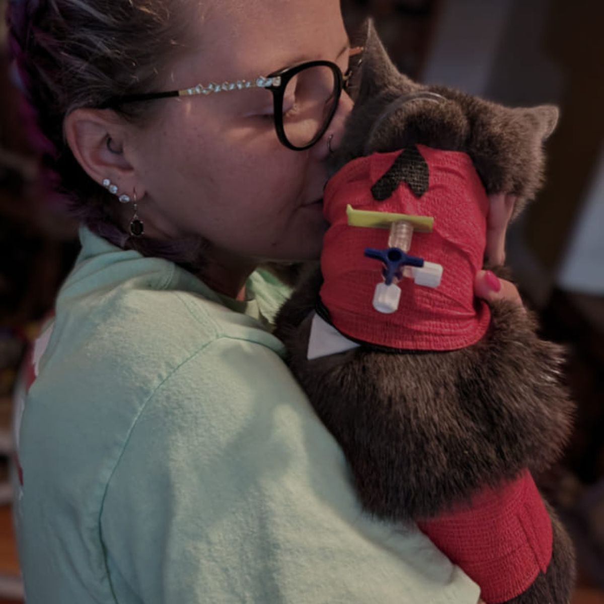 woman kissing the cat