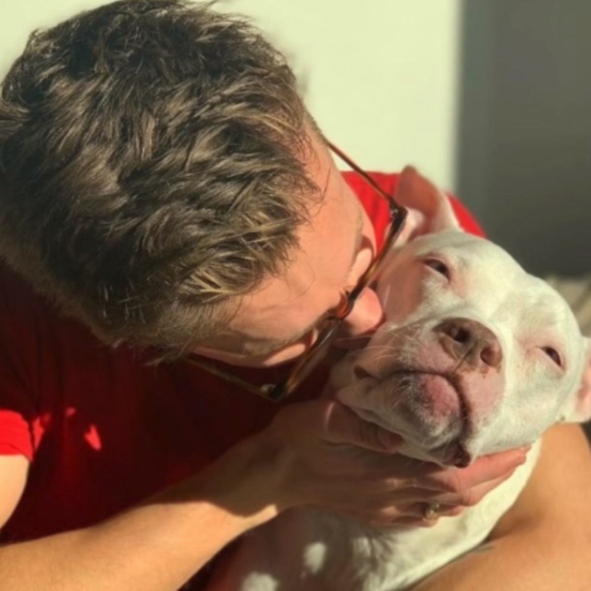 woman kissing the dog