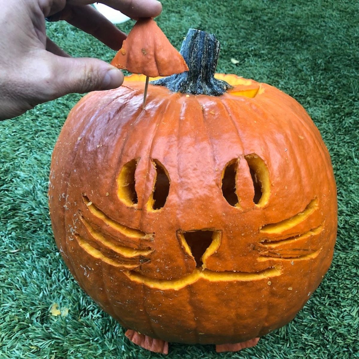 decorating a pumpkin for halloween
