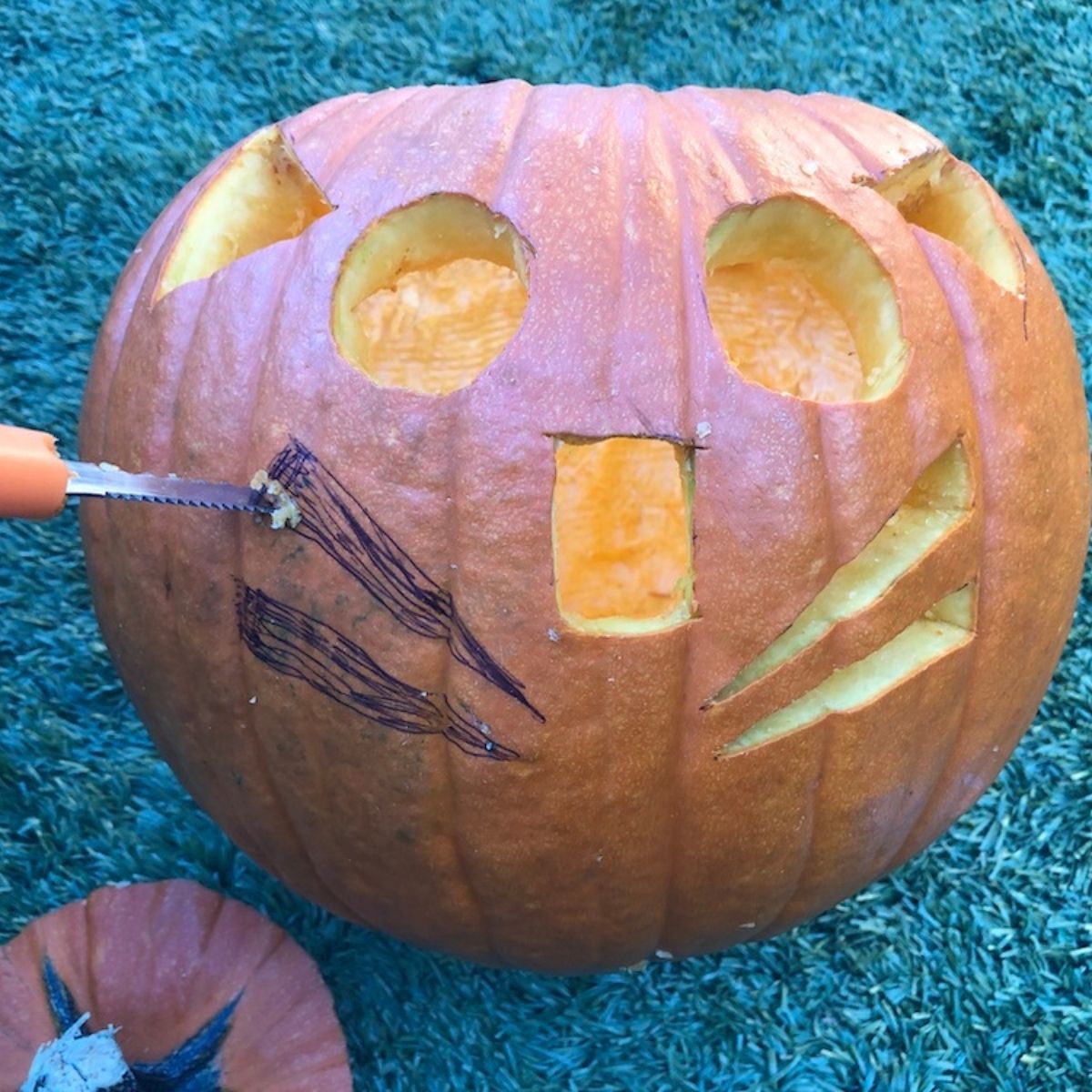 decorating a pumpkin for halloween