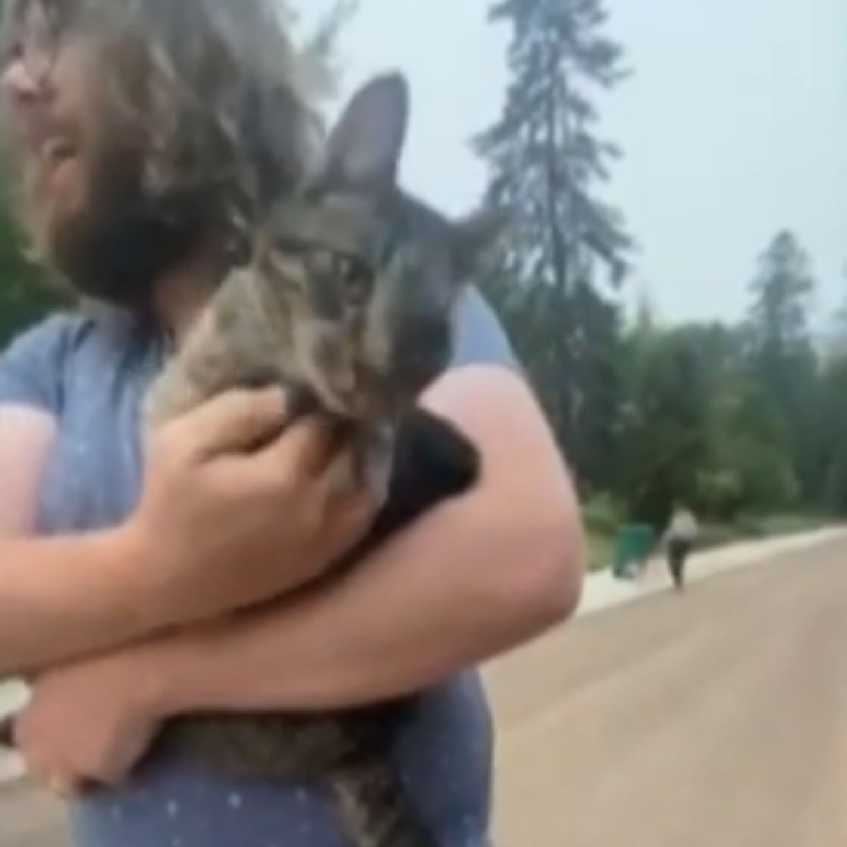 man carrying senior cat