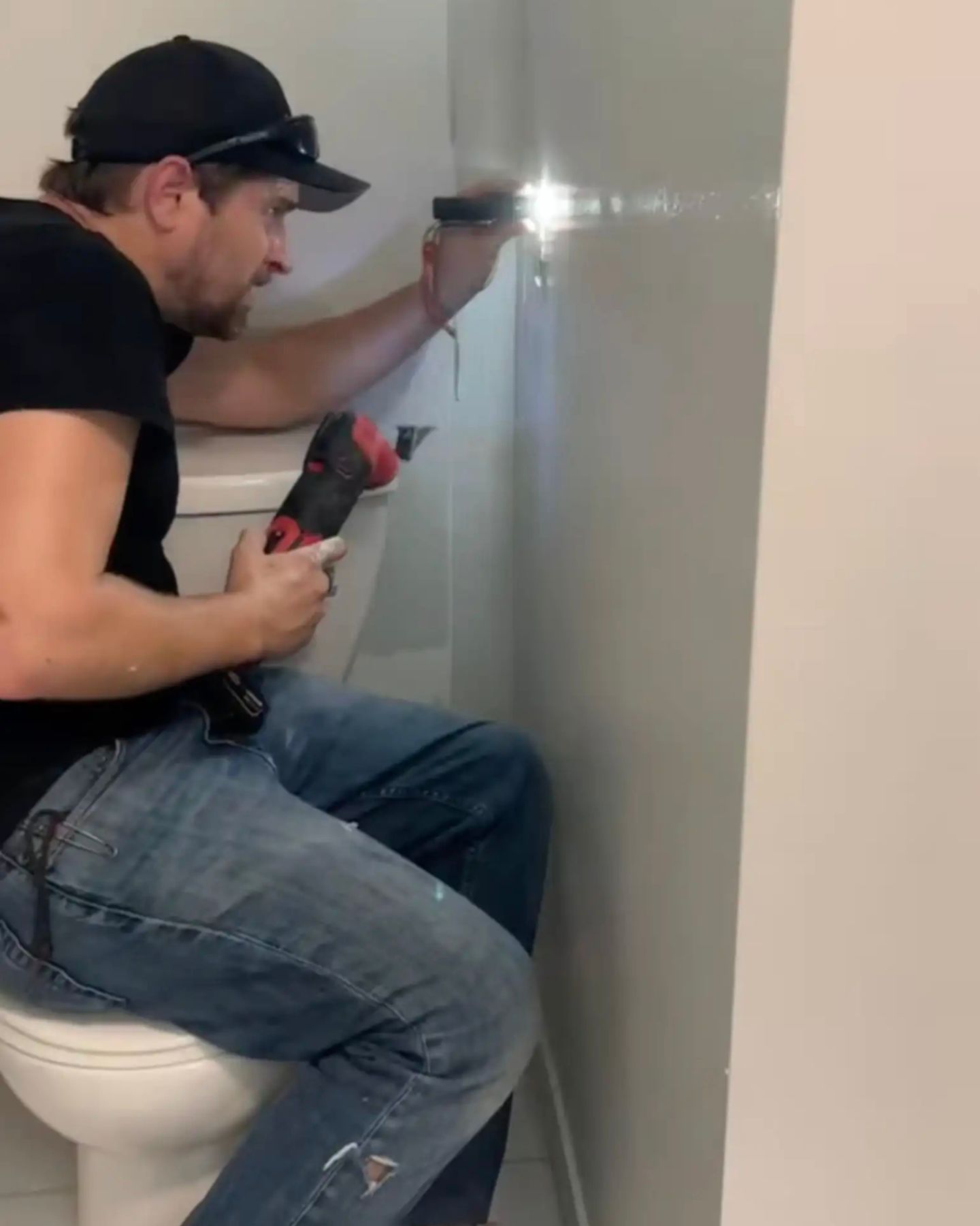 man drilling a wall