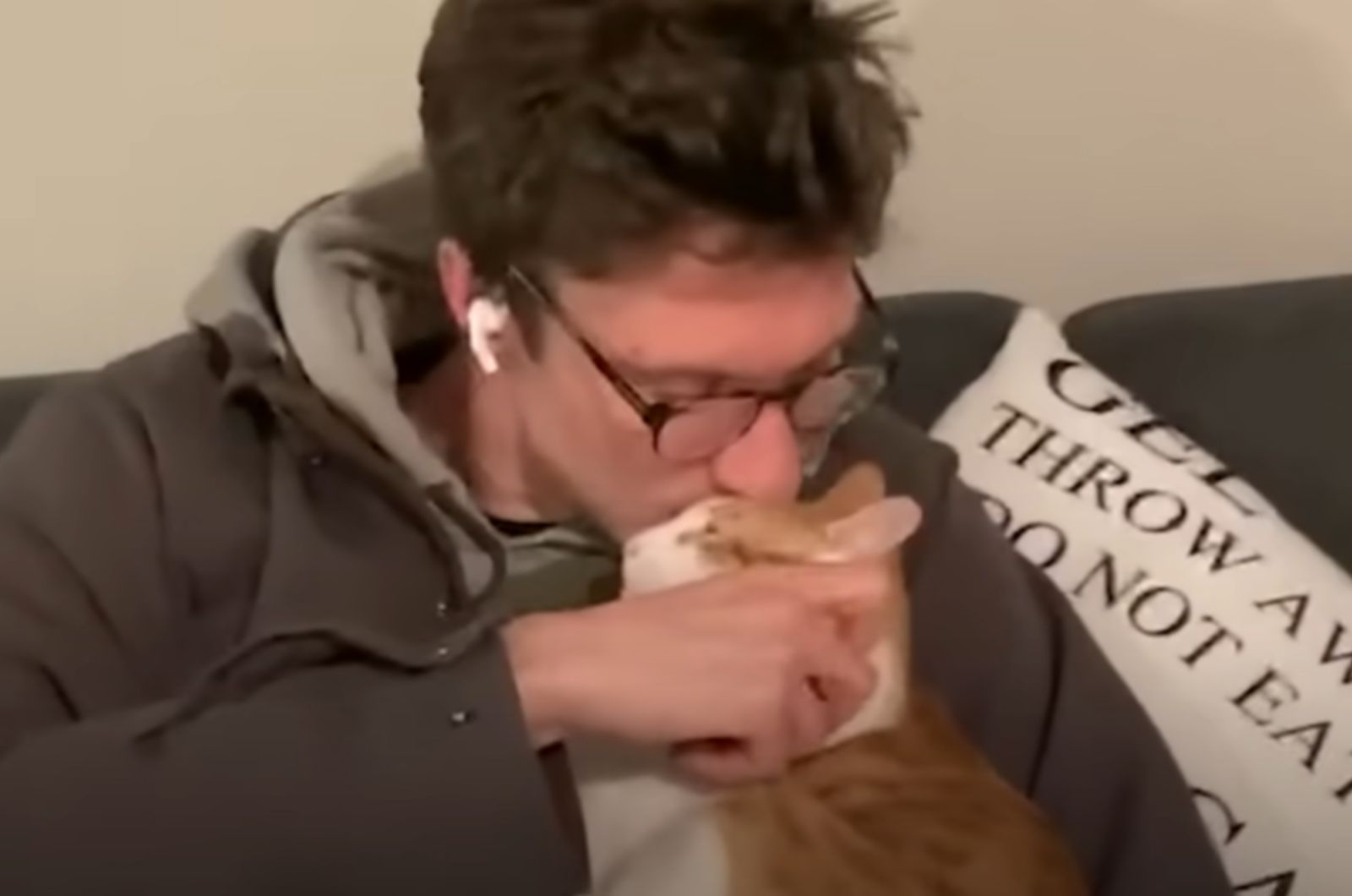 man kisses a kitten