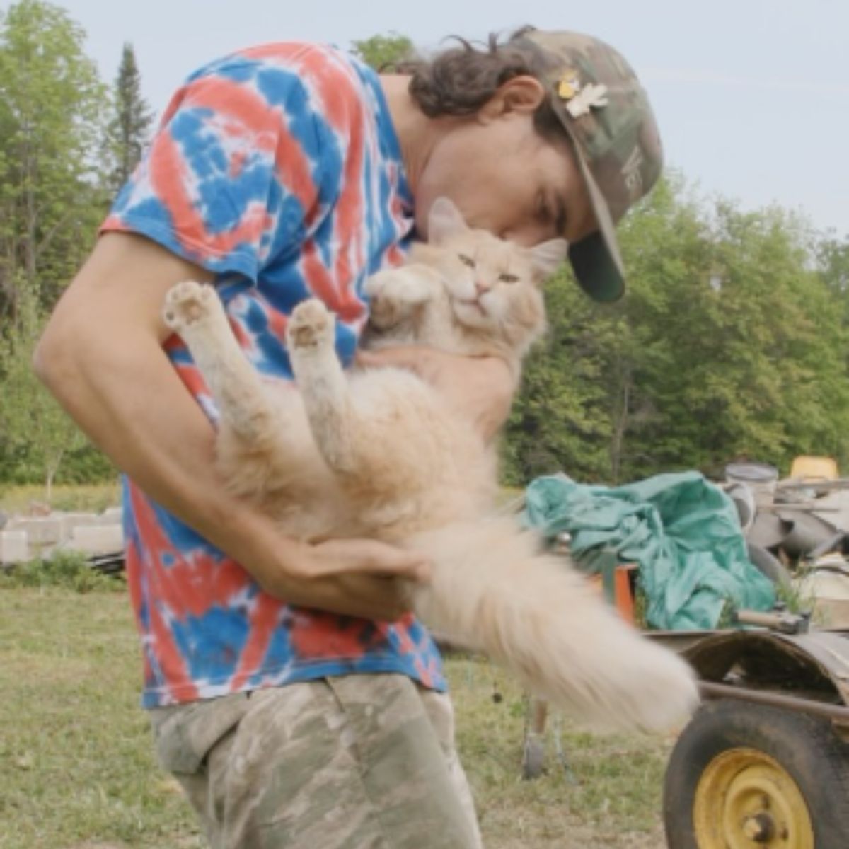man kissing cat