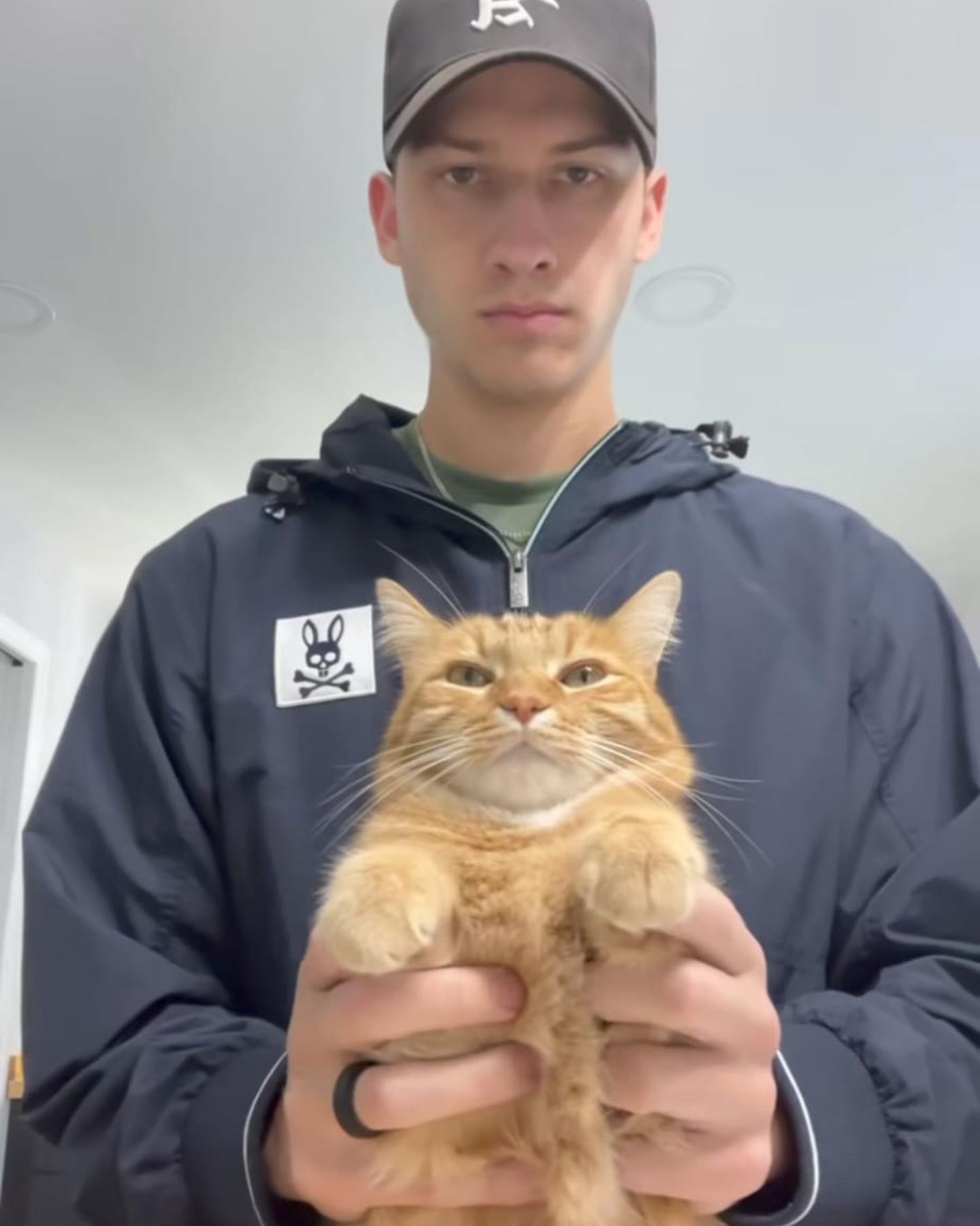 man with ginger cat