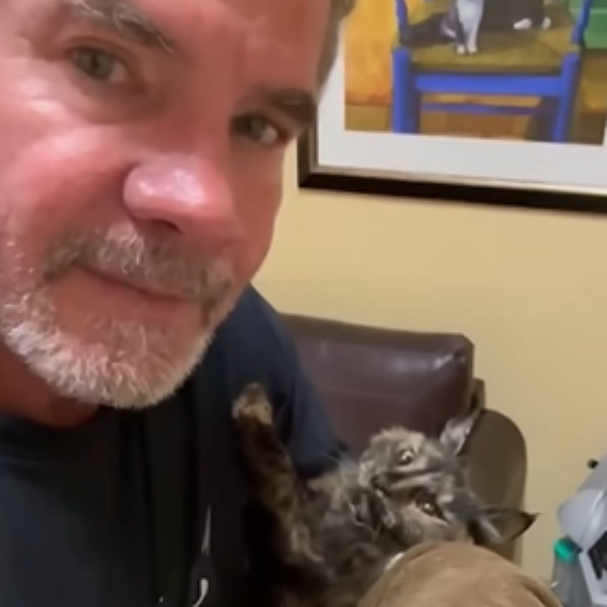man with scared cat