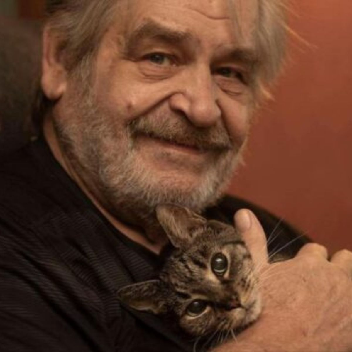 man with senior cat