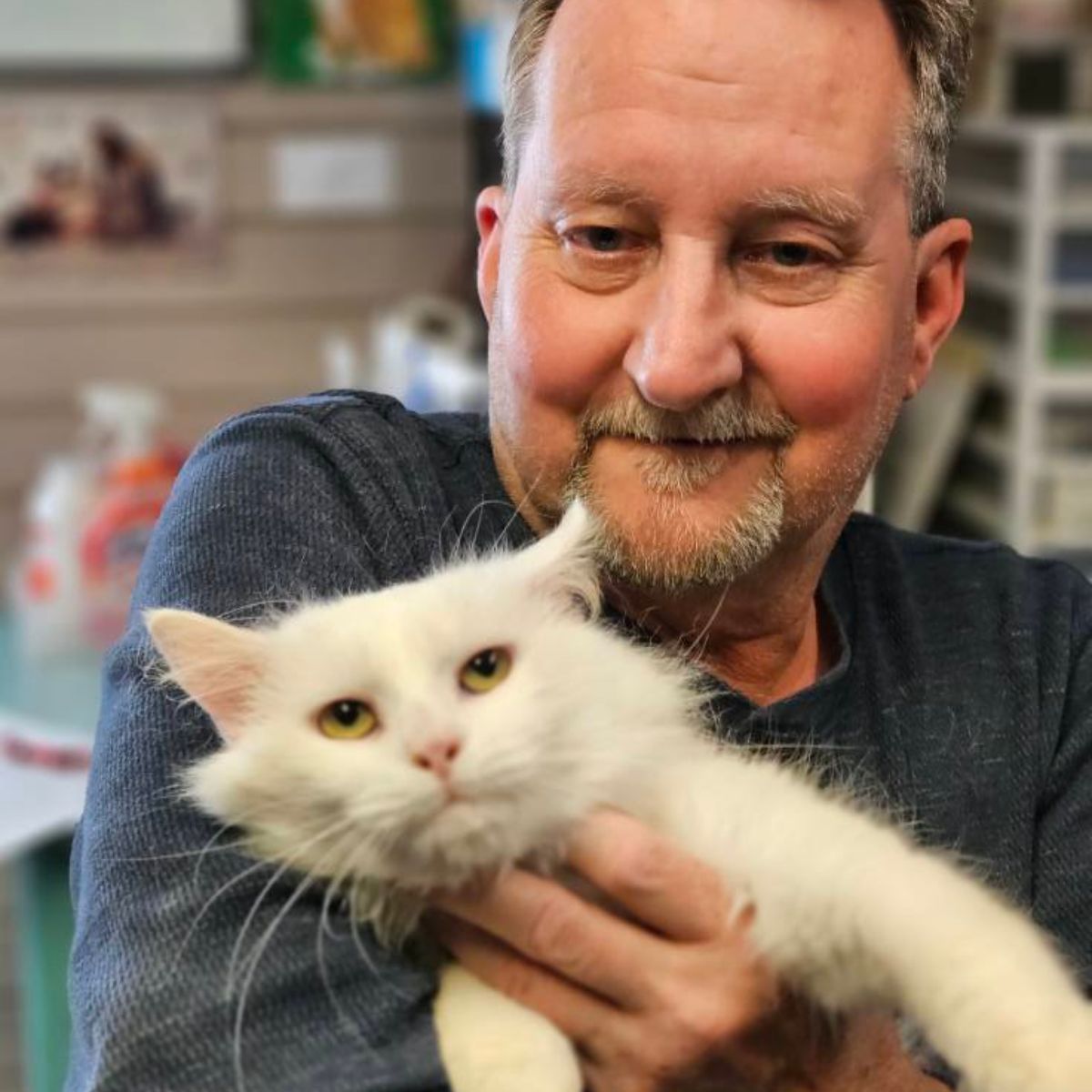 man with the white cat
