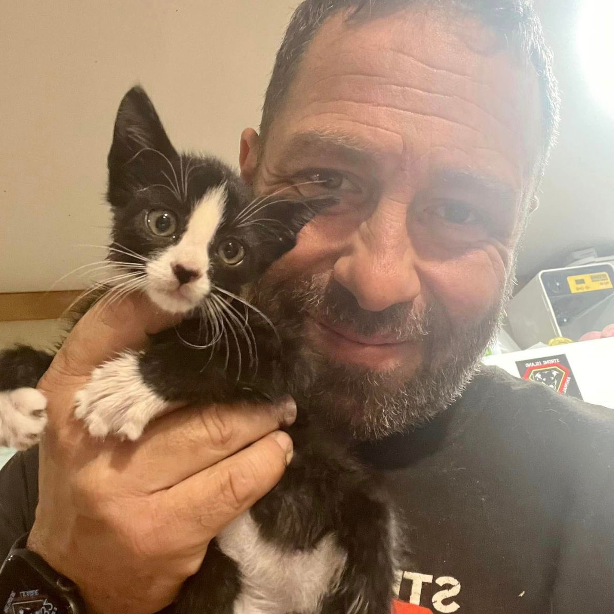 rescued kitten and man