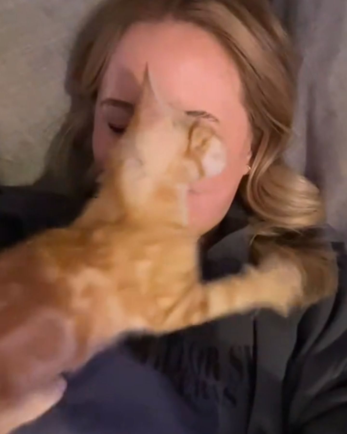 woman and a kitten are cuddling