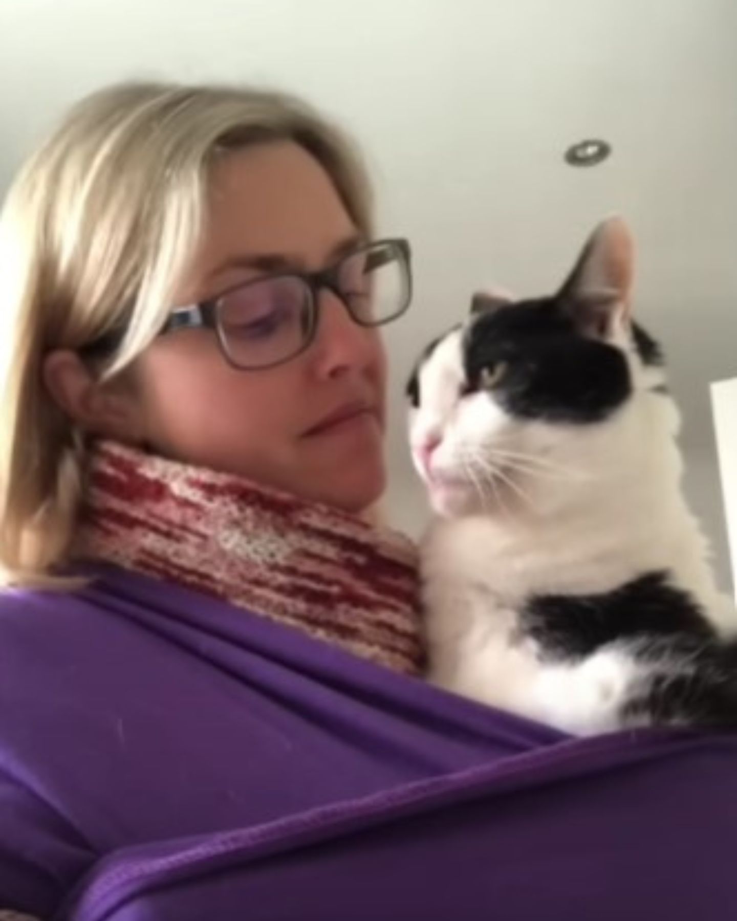 woman carrying cat