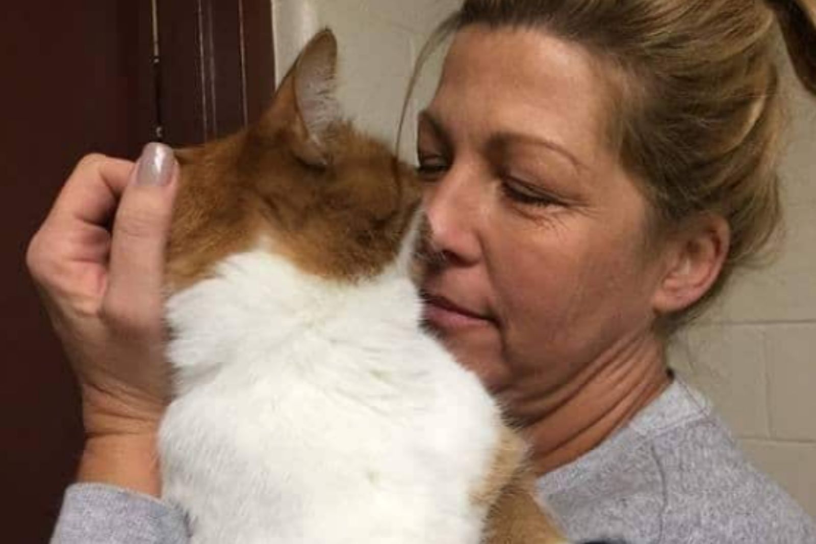 woman cuddles with a cat