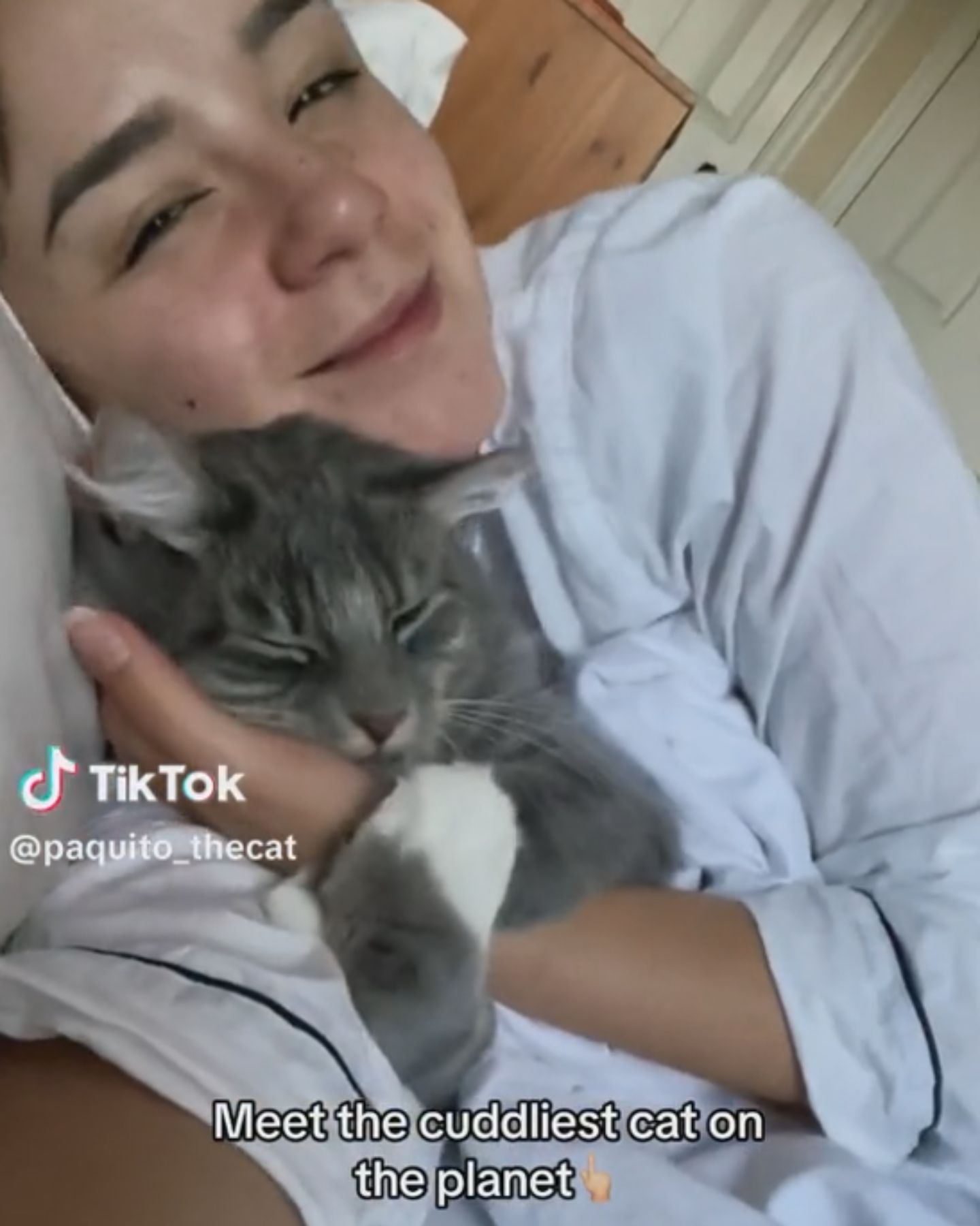 woman cuddling with cat