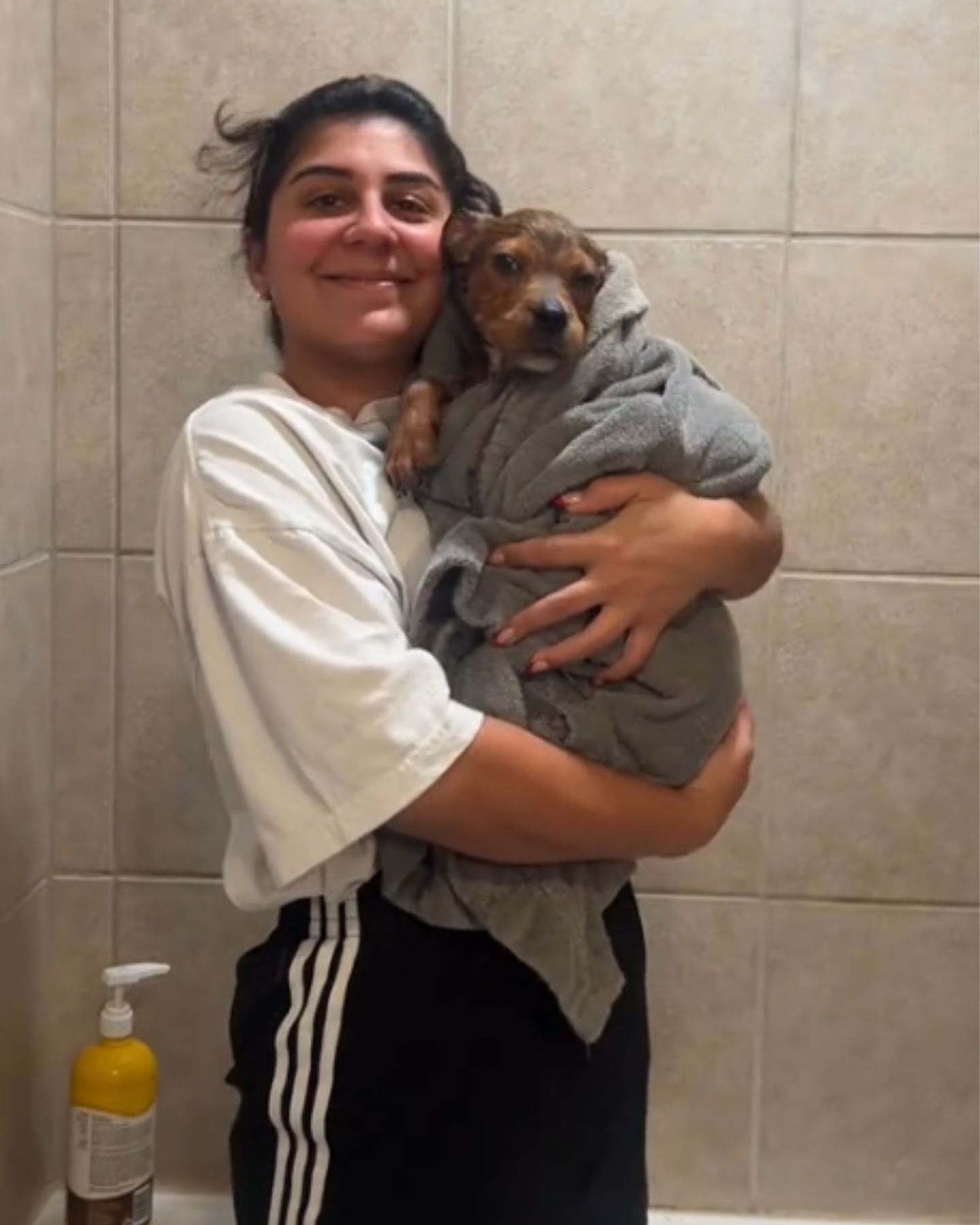 woman hugs a small dog