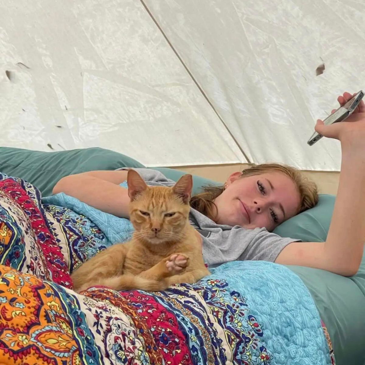woman in tent with cat