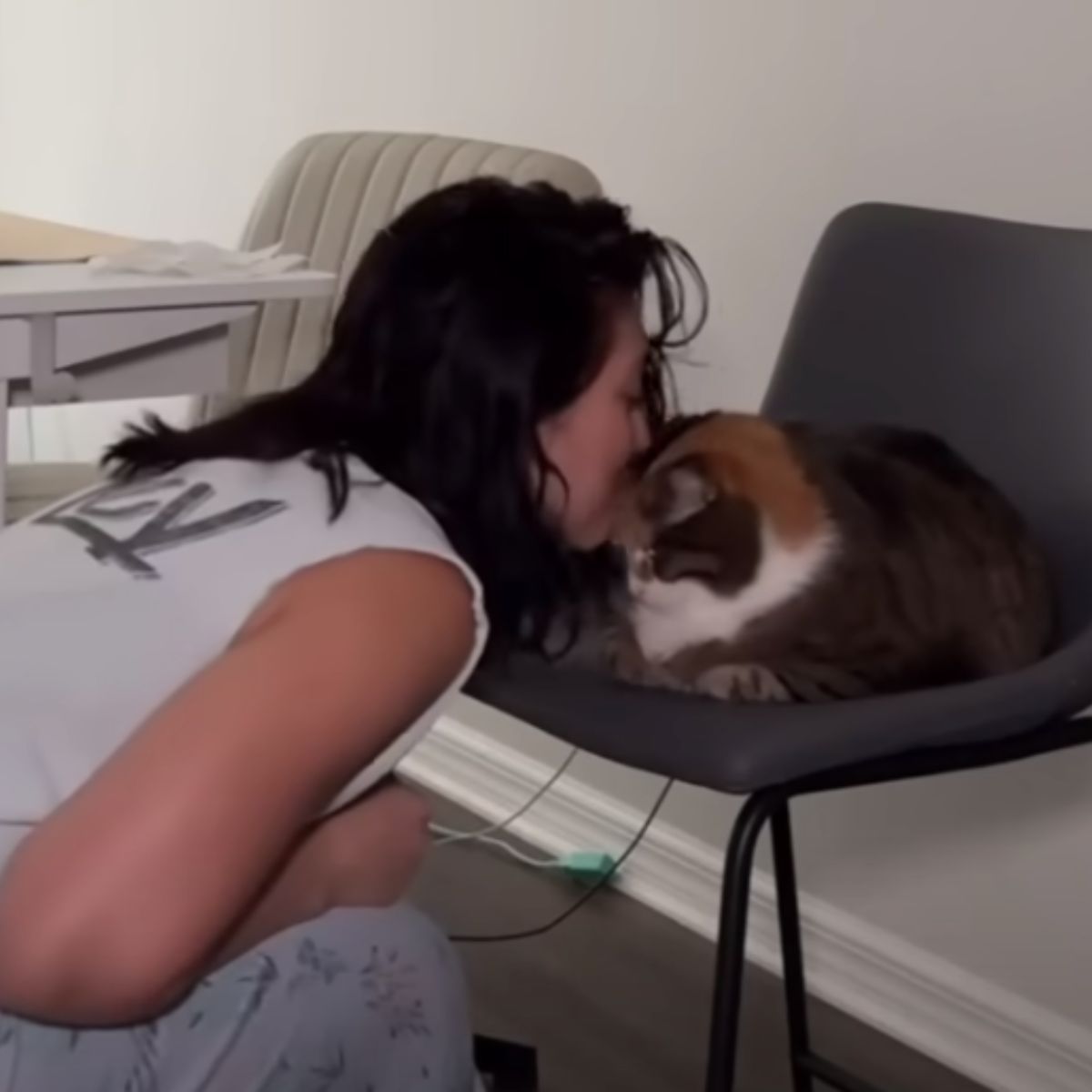 woman kissing cat
