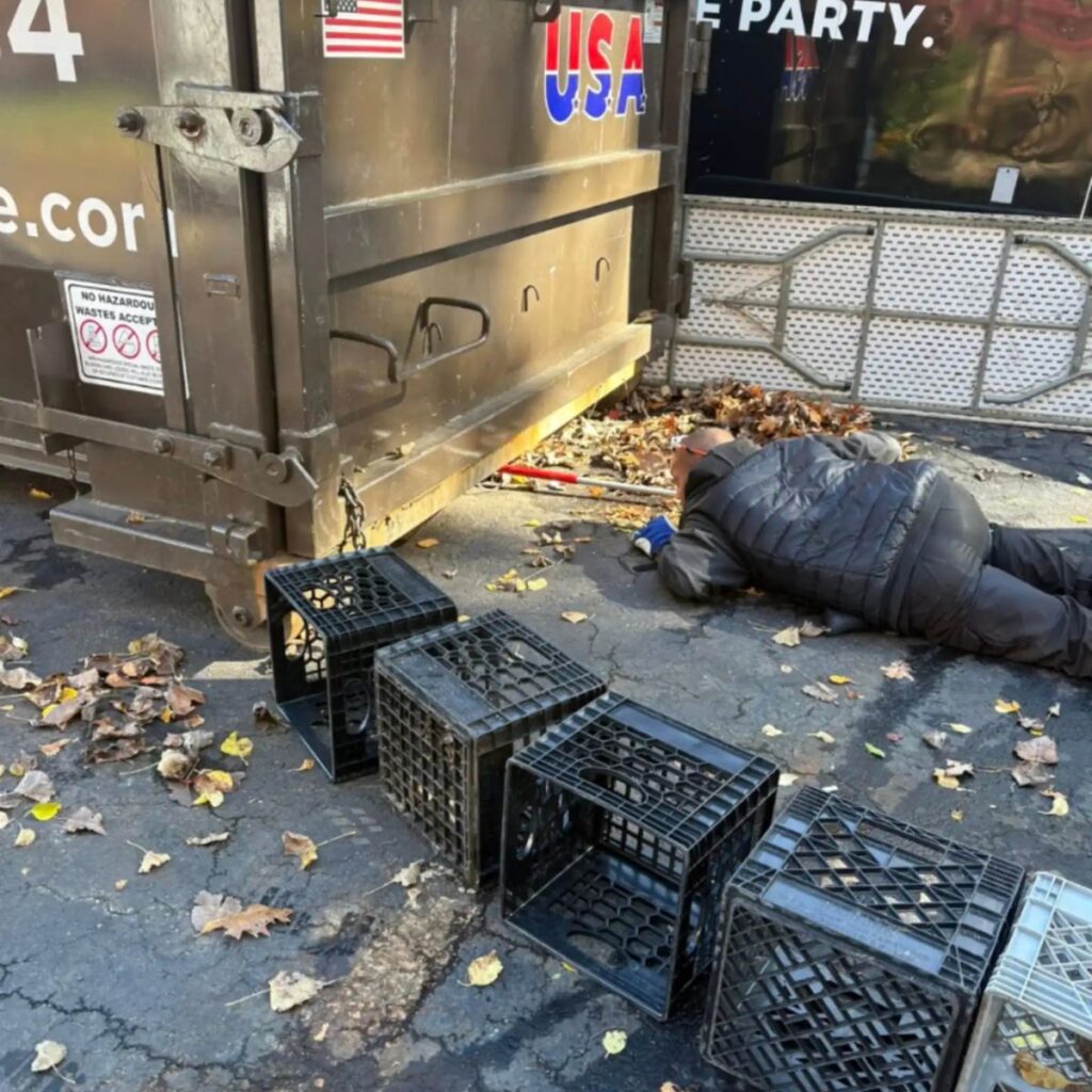A man is taking something out from under a container