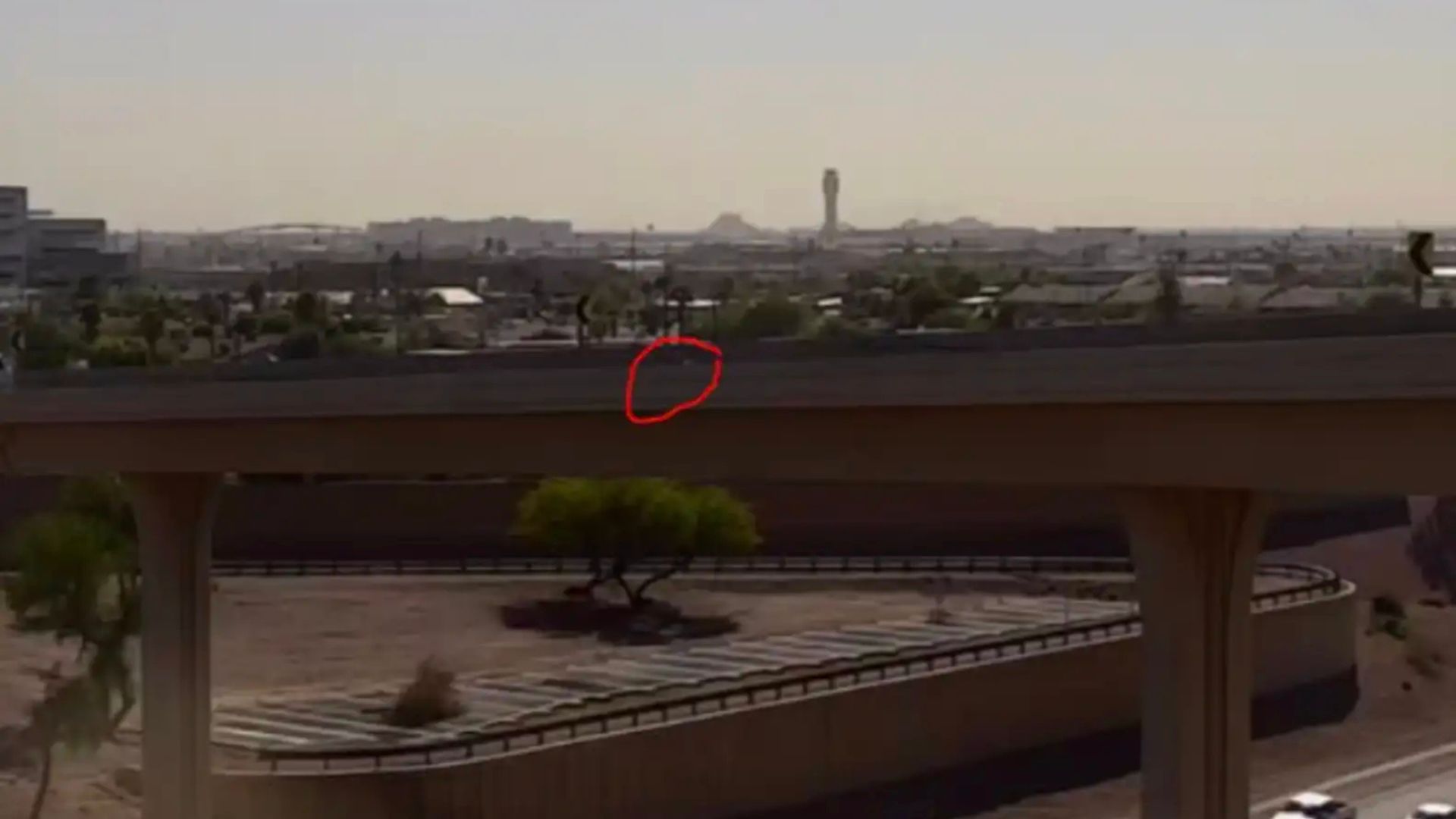 white speck on the side of a freeway ramp