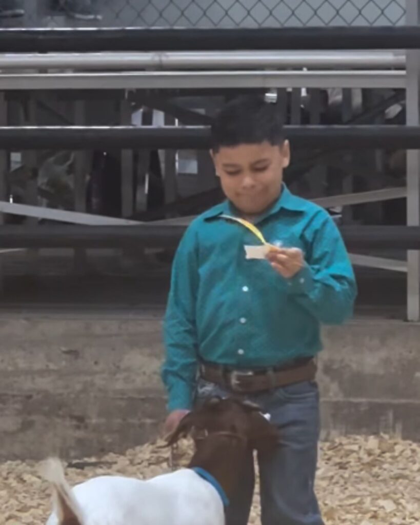 The boy is reading something on paper