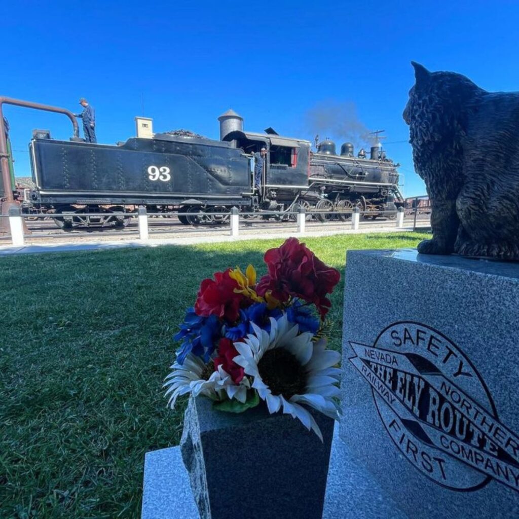 The cat is sitting on the monument