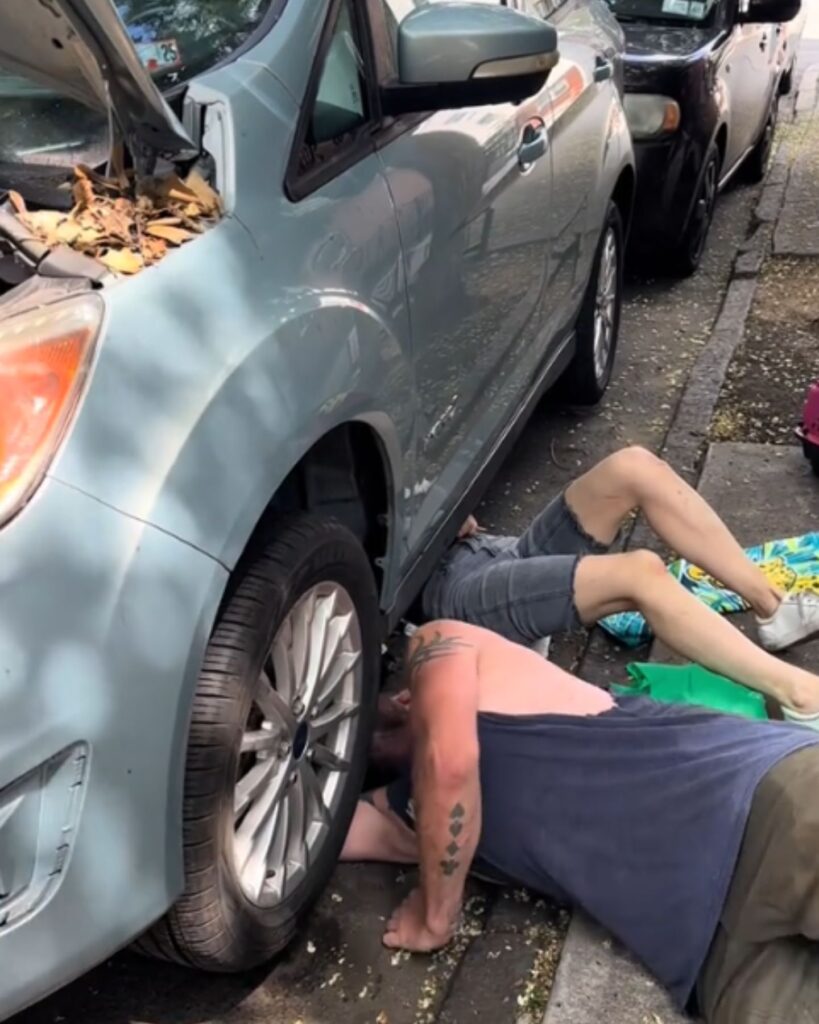 man and woman under the car