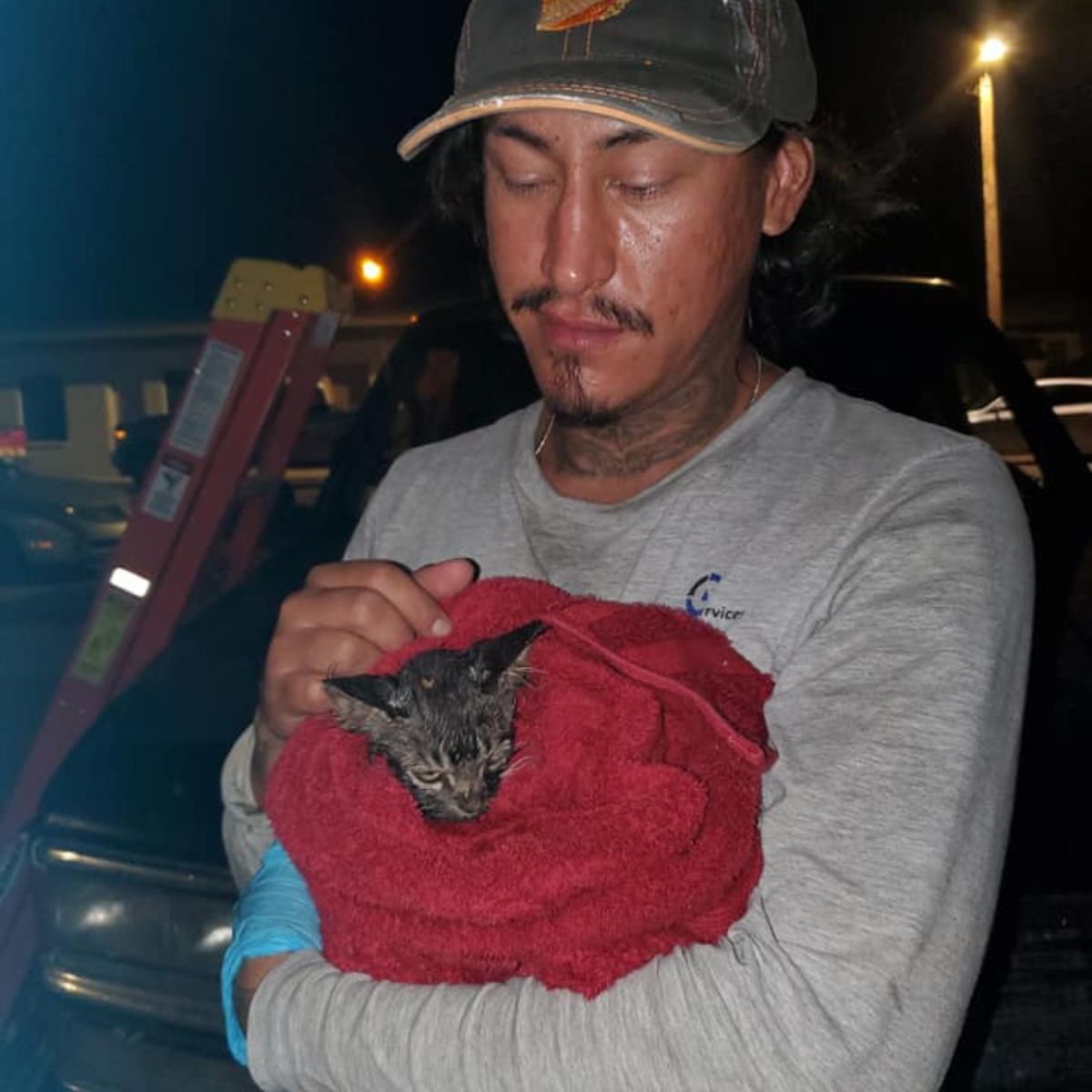 man with rescued kitten